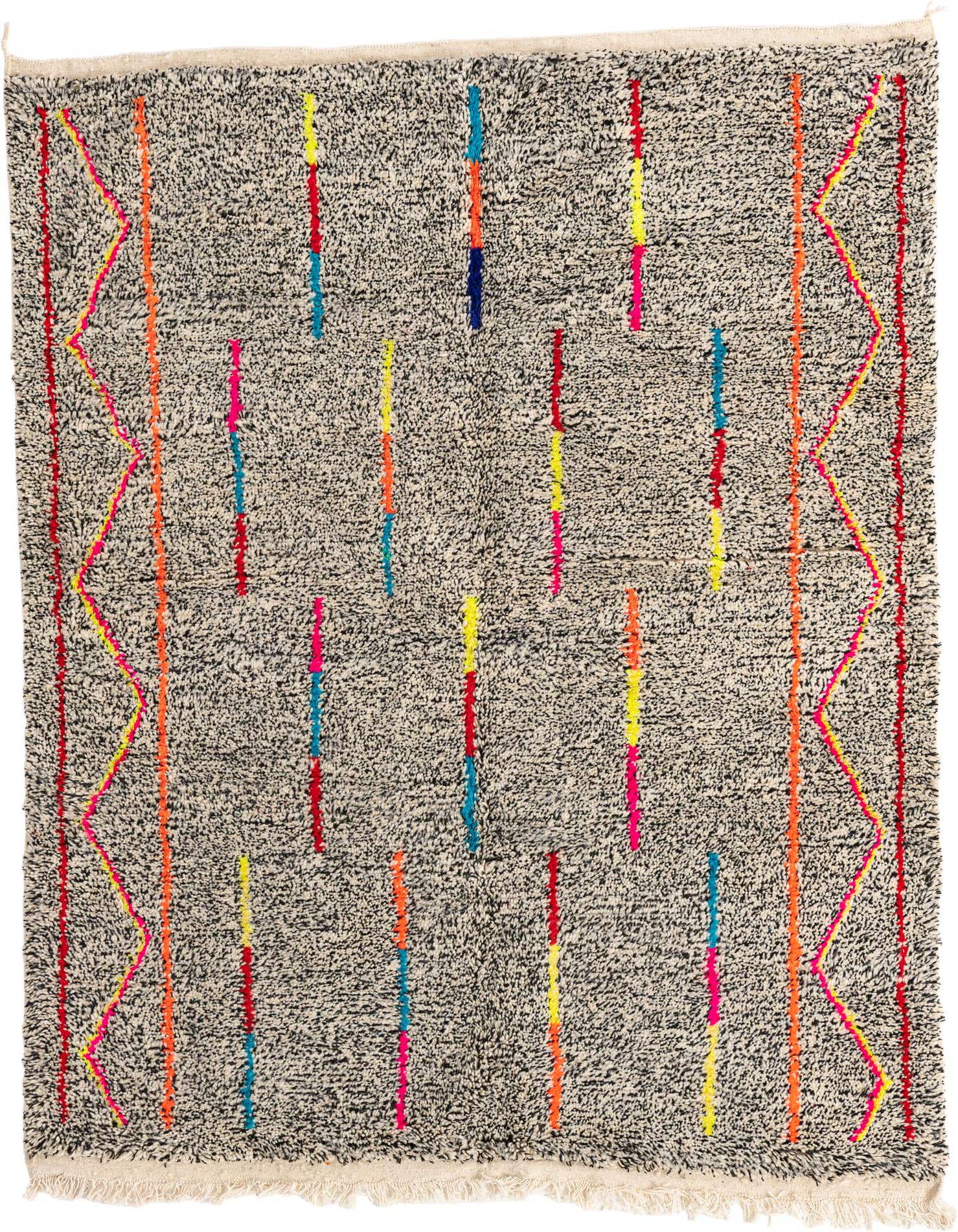 A 5x8 rectangular black shag rug with a tribal pattern featuring colorful vertical stripes and zigzag borders in neon pink, orange, yellow, and blue.