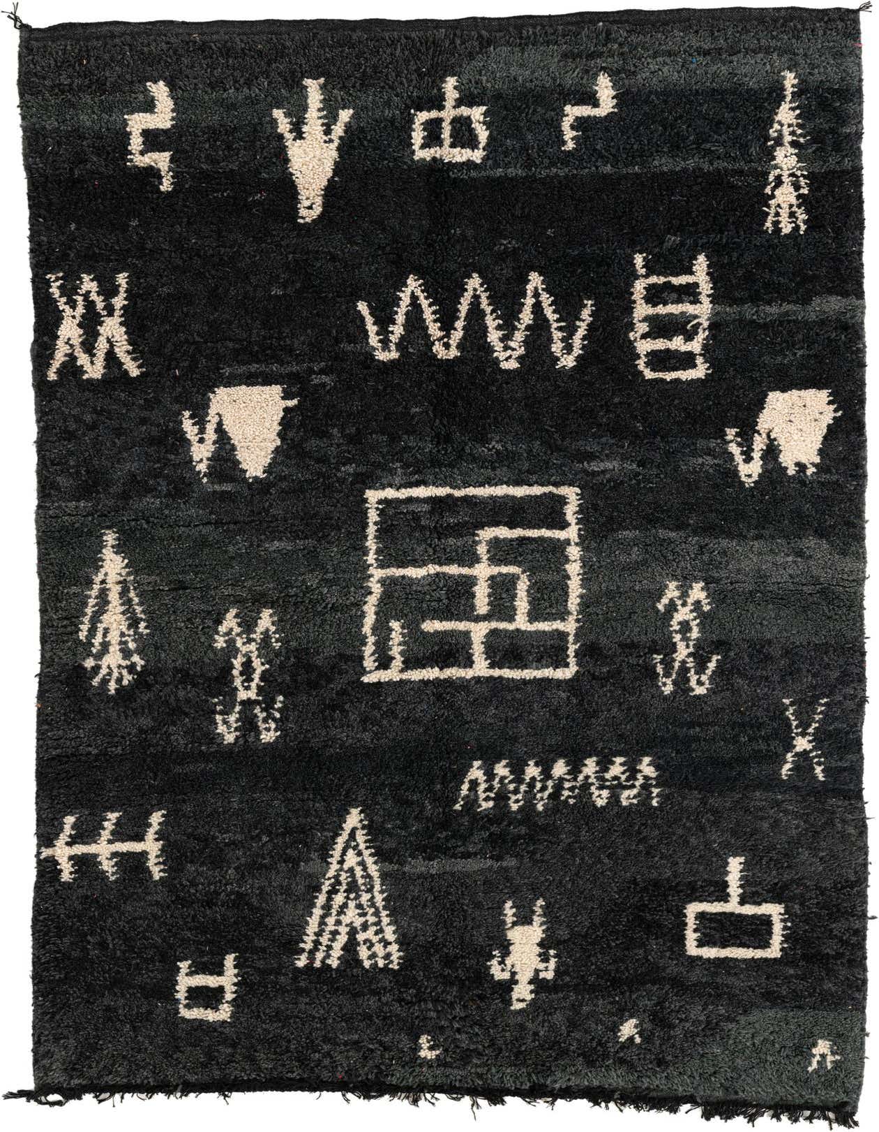 A 5x8 rectangular black shag rug with varied cream tribal and abstract patterns, perfect for a modern living room.