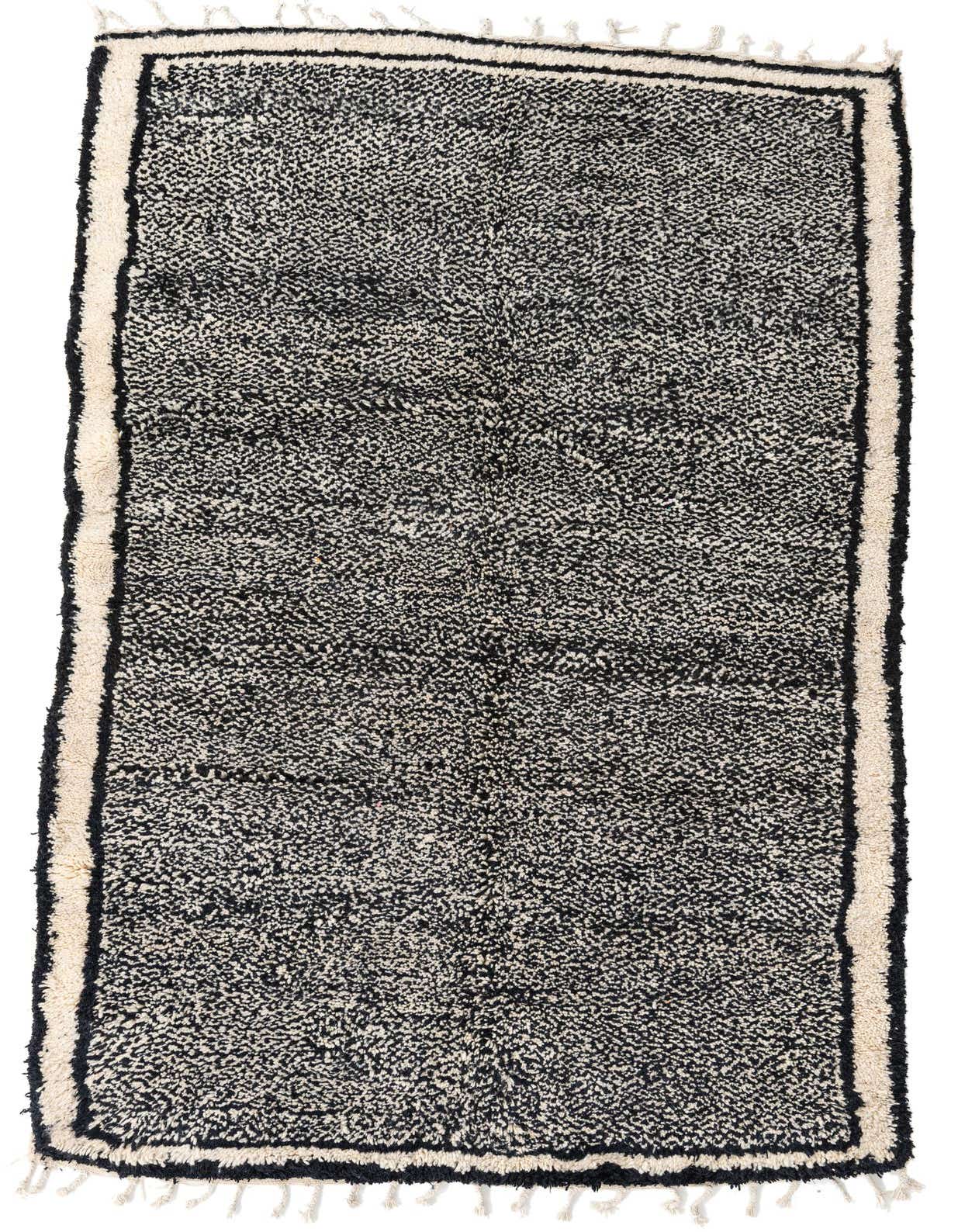 A 5x8 rectangular black and off-white shag rug with a tribal pattern and border, suitable for a living room.