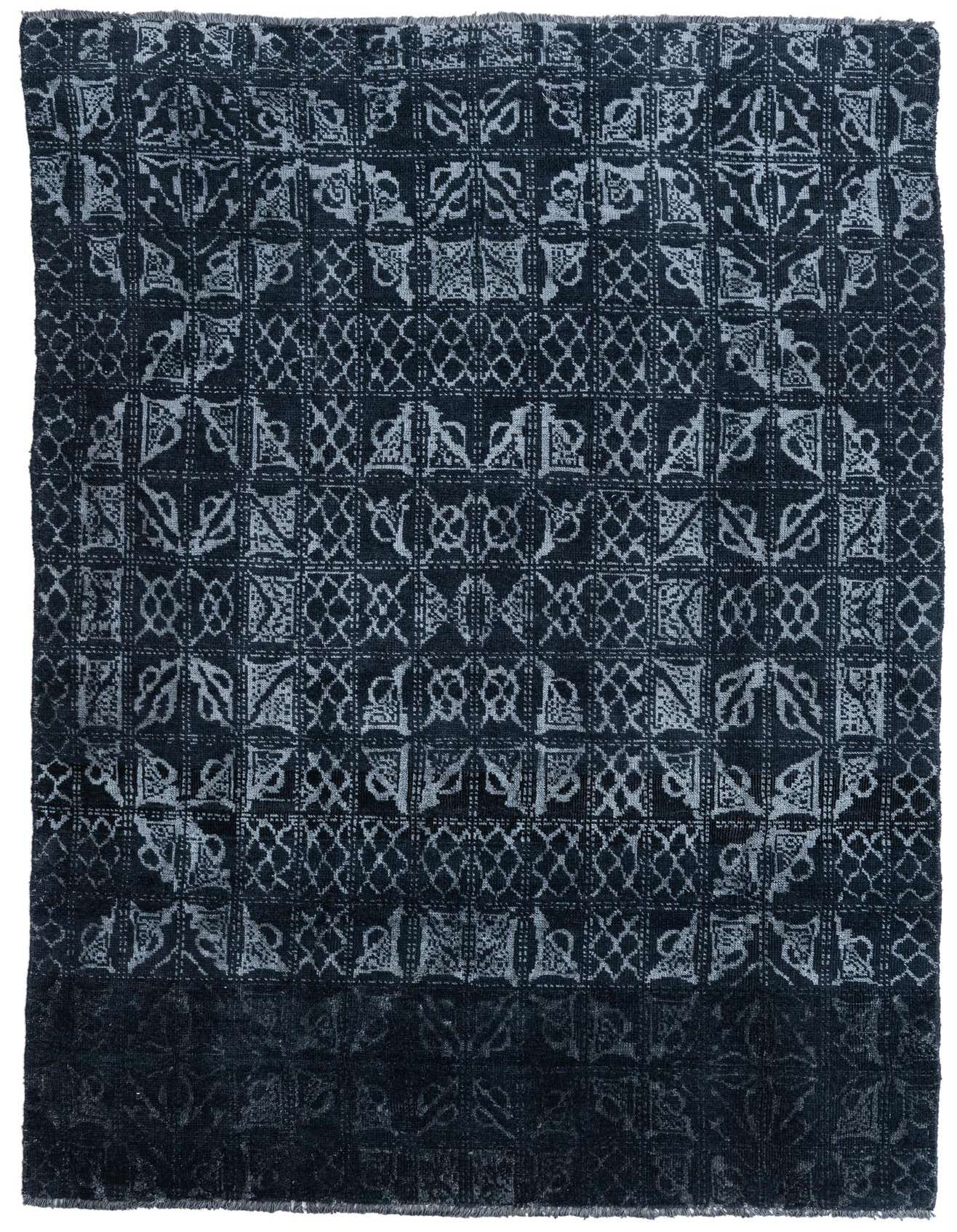 A 6x9 rectangular black shag rug with a faded tribal and abstract pattern in lighter black tones, suitable for a living room.