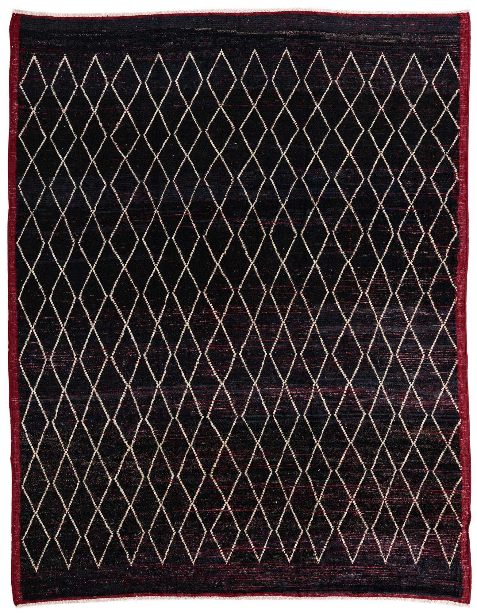 A 9x12 rectangular black wool shag rug with a repeating white diamond tribal pattern and a deep red border.
