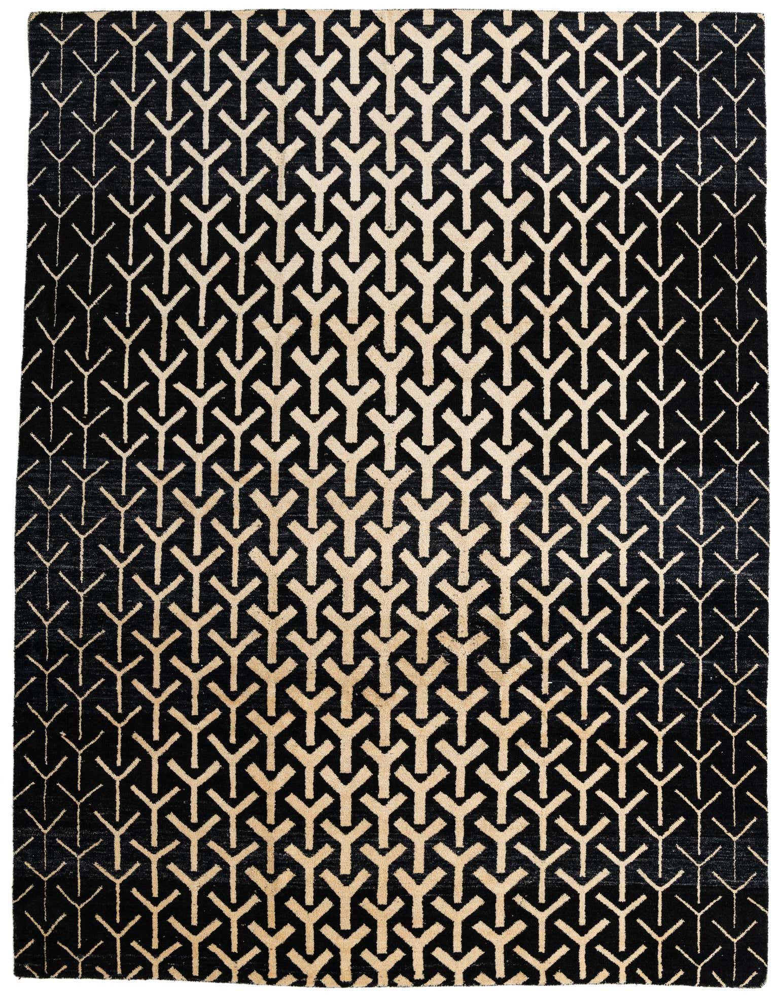 A 9x12 rectangular black wool shag rug with an abstract, repeating Y-shaped tribal pattern in varying shades of cream and beige, suitable for a living room.