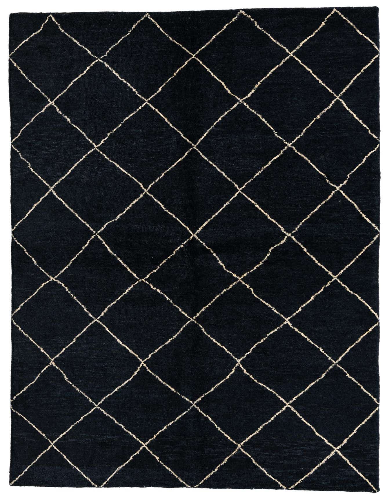 A 6x9 rectangular black wool shag rug with a cream tribal diamond pattern, ideal for a living room or bedroom.