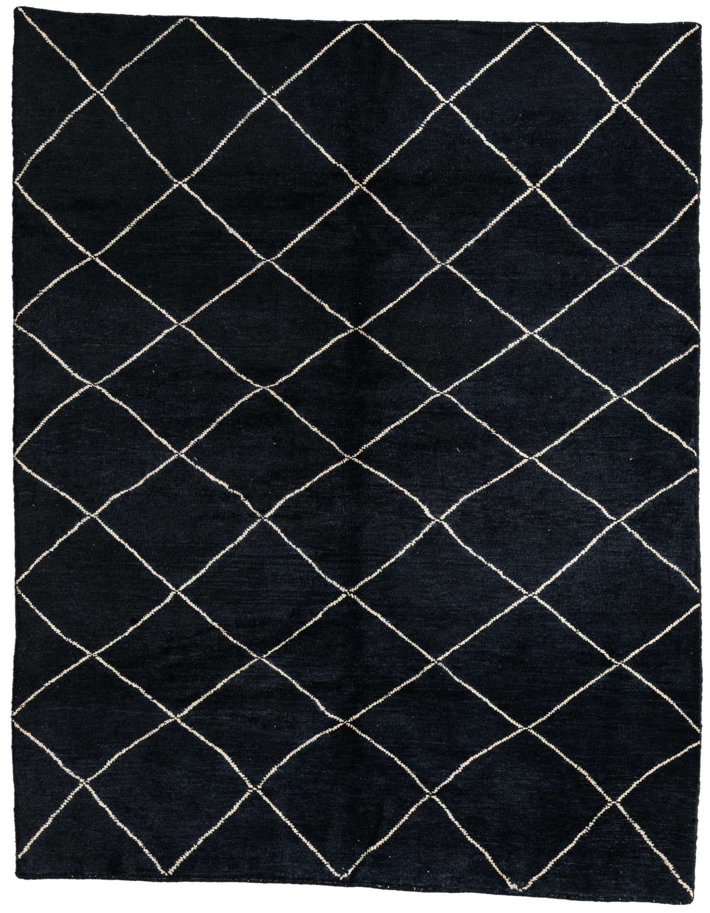 A 6x9 rectangular black shag rug with a white tribal diamond pattern, ideal for a living room or bedroom.