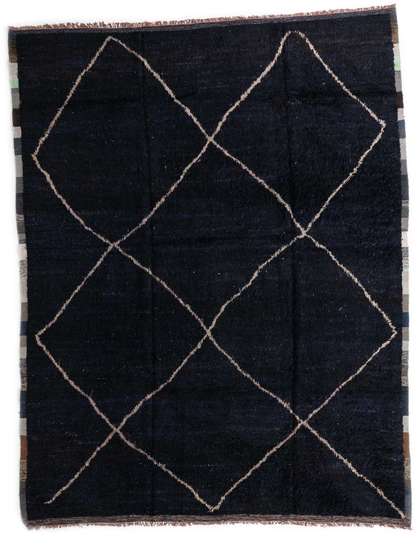 A 10x14 rectangular black Moroccan shag rug with a cream tribal diamond pattern, handmade from 100% wool.