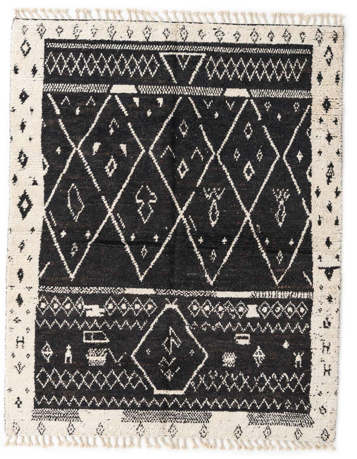 A 5x8 rectangular black and white Moroccan shag rug with tribal diamond patterns and fringe, perfect for a living room.