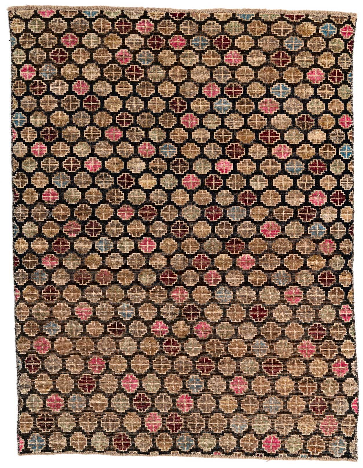 A 5x8 rectangular black shag rug with a tribal, modern, and oriental pattern of repeating multi-colored geometric shapes in pink, blue, and brown.