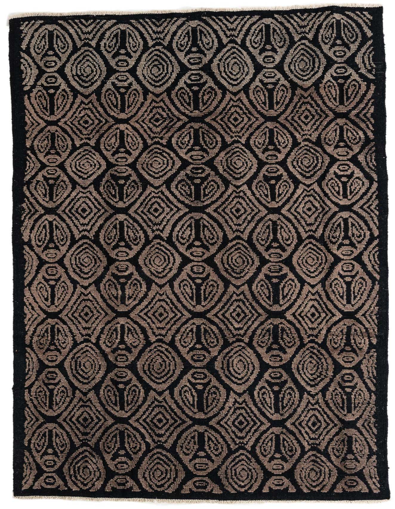 A 6x9 rectangular black wool shag rug with a repeating tribal geometric pattern in dark brown, perfect for a modern living room.