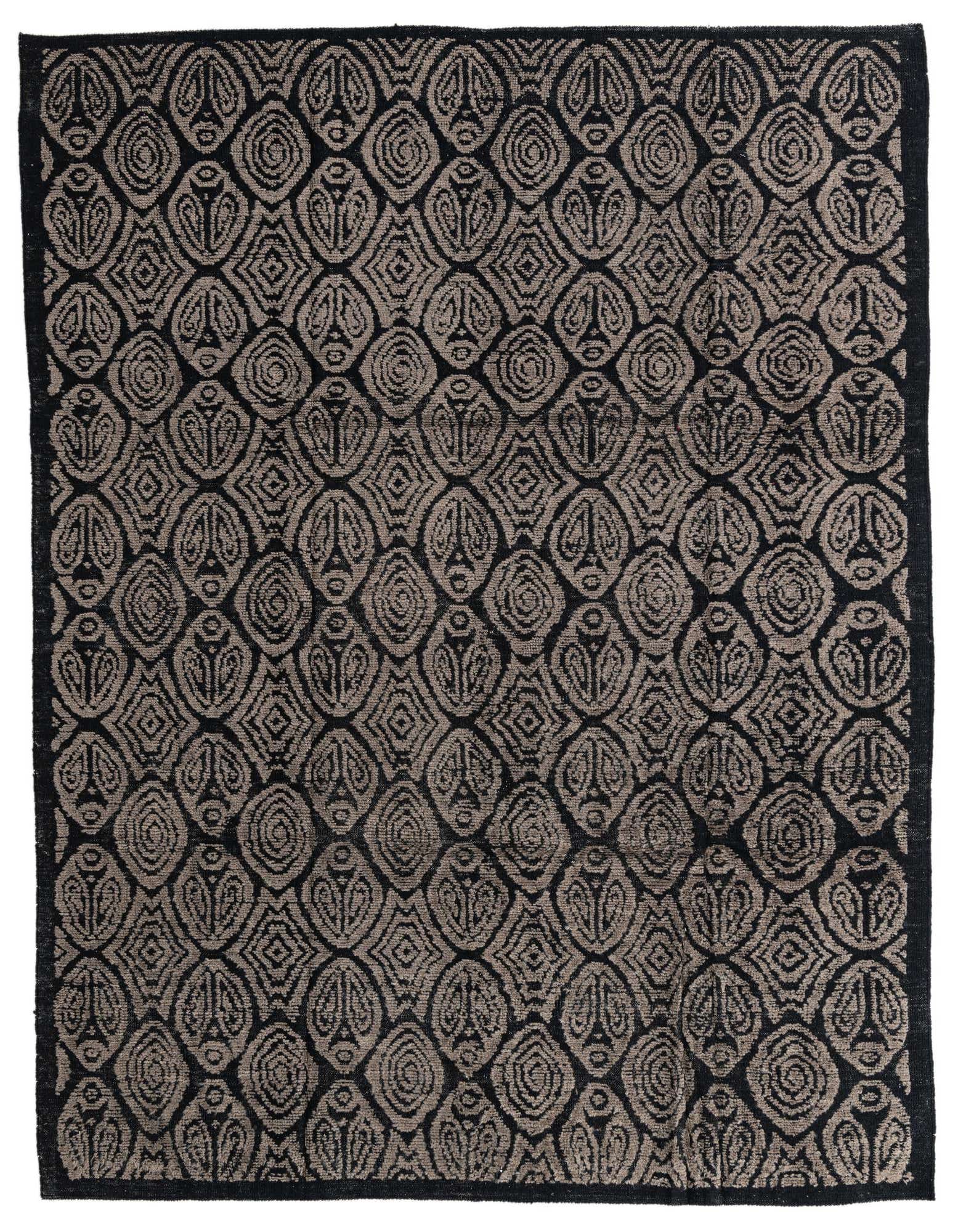 An 8x10 rectangular black wool shag rug with a repeating modern tribal pattern in varying shades of black and dark gray.