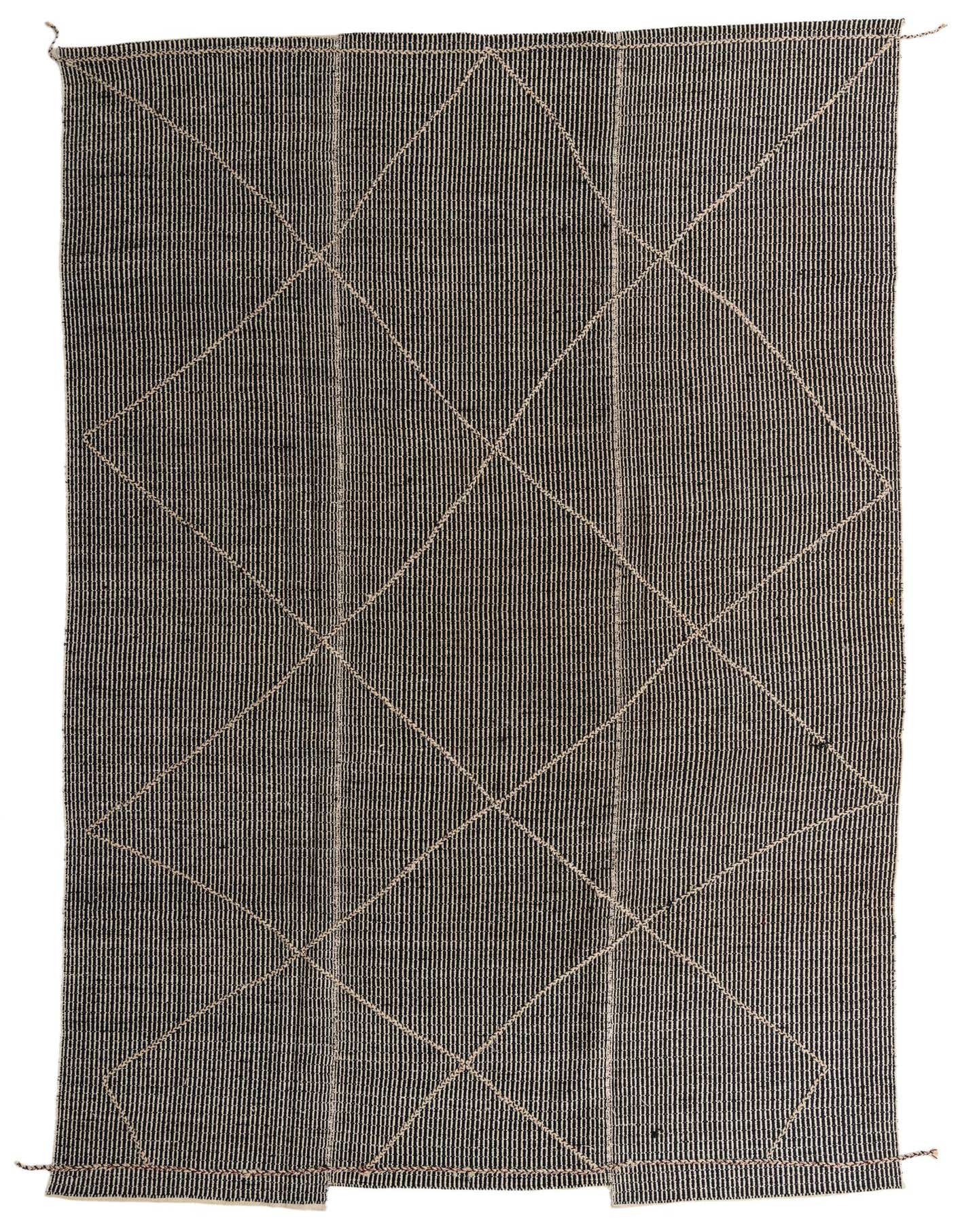 A 10x14 rectangular black wool shag rug with a subtle tribal diamond pattern in lighter tones, suitable for an indoor living space.