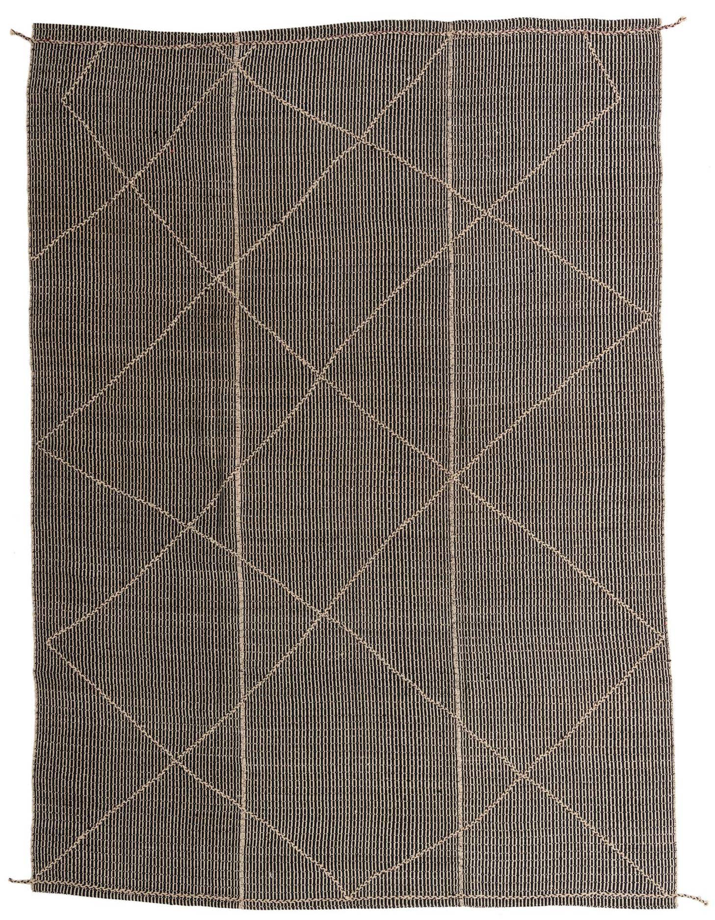 A 10x14 rectangular black wool shag rug with a subtle beige tribal diamond pattern, ideal for indoor spaces.
