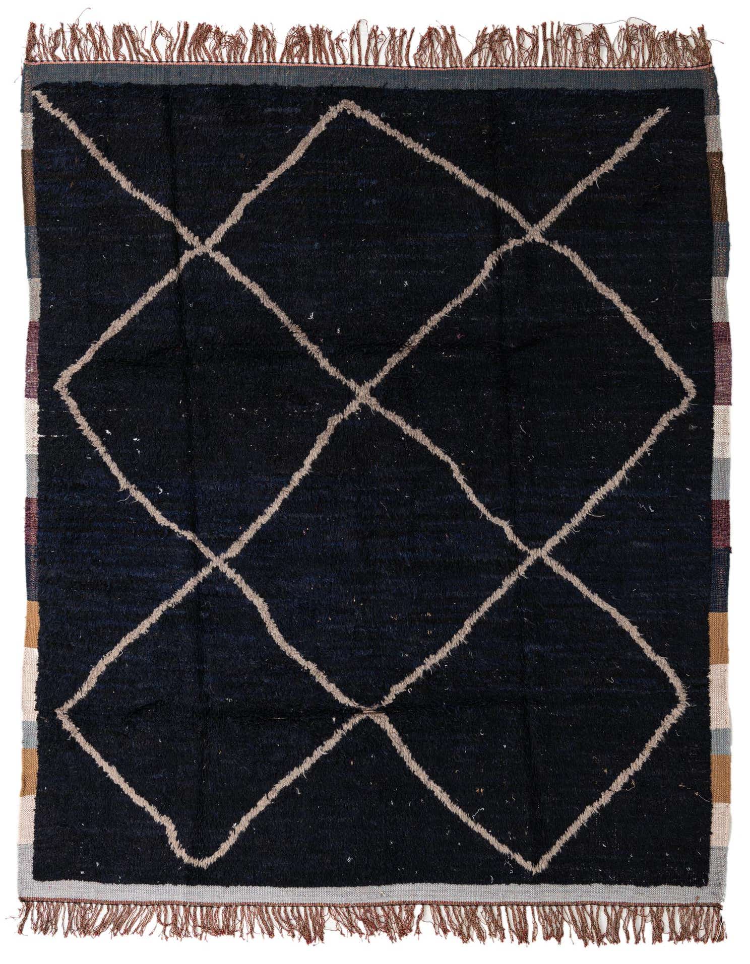 A rectangular 8x10 black shag rug with a cream tribal diamond pattern and fringed edges, suitable for a living room.