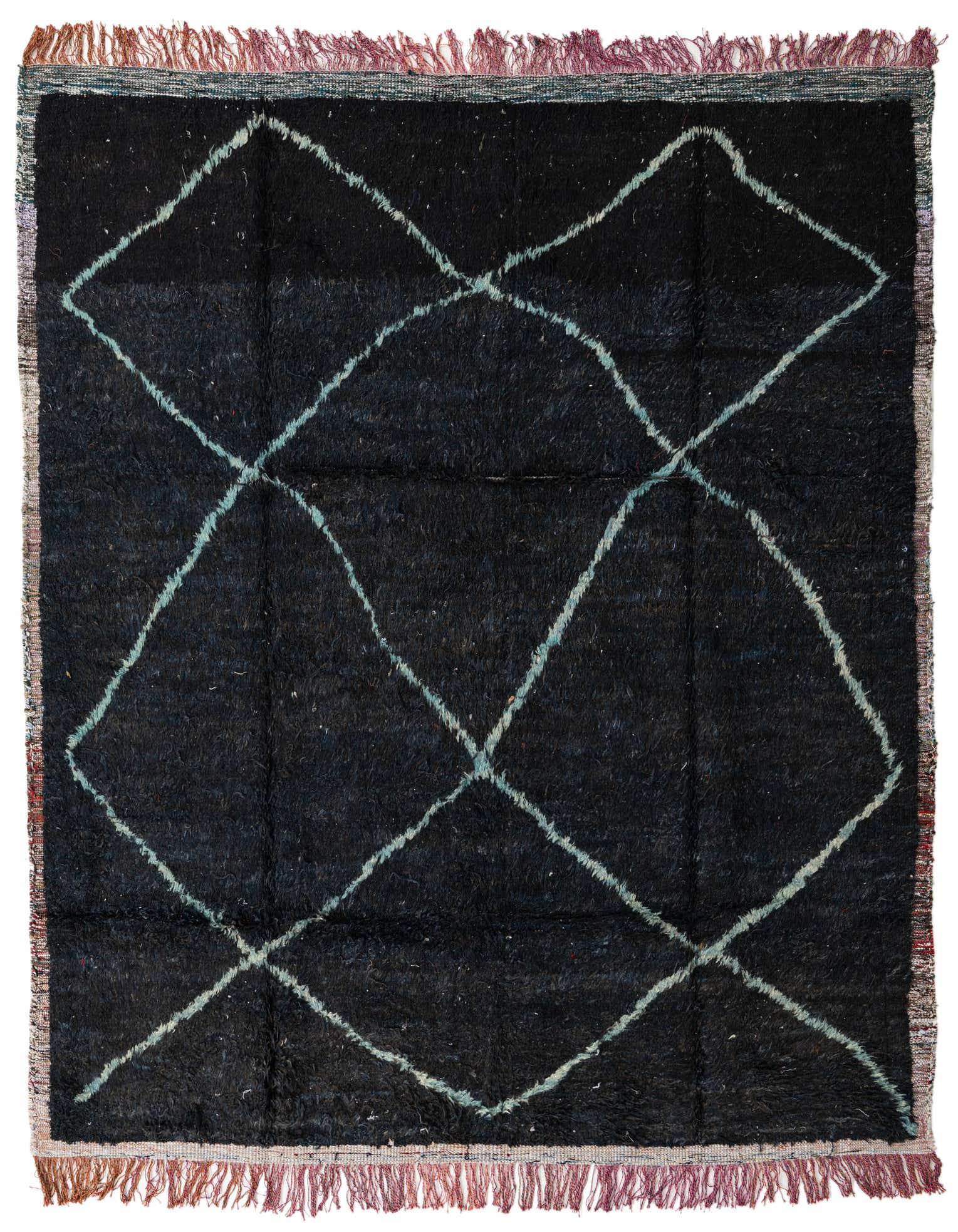A rectangular 8x10 black shag rug with a white tribal diamond pattern and colorful fringed edges, suitable for a living room.