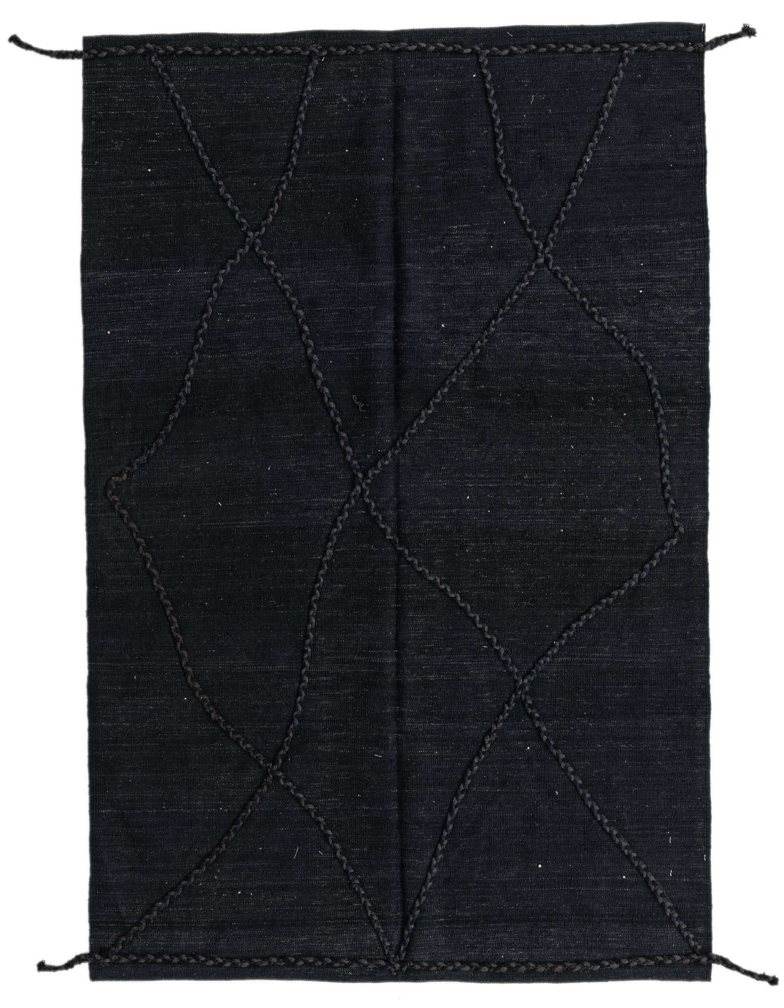 A 4x6 rectangular black wool shag rug featuring a subtle tribal diamond pattern, ideal for a modern living room.