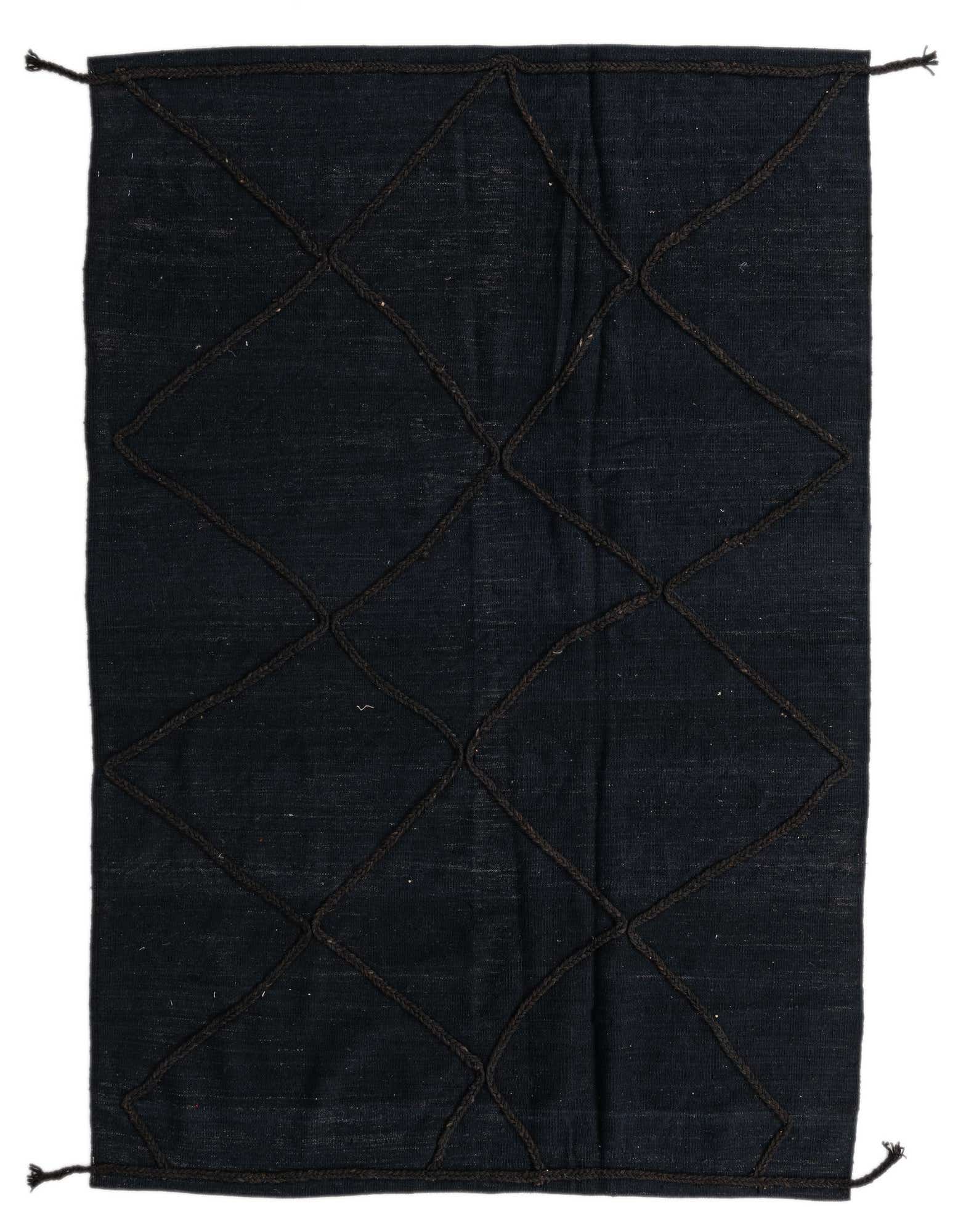 A 5x8 rectangular black wool shag rug with a dark braided tribal diamond pattern, ideal for a living room.