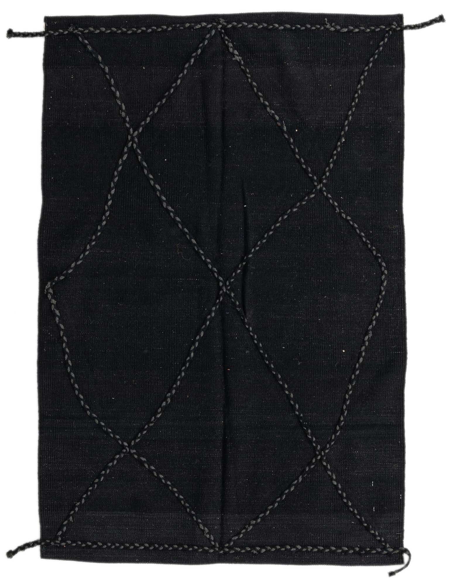 A 3x5 rectangular black wool shag rug with a modern tribal diamond pattern, handmade for indoor use.