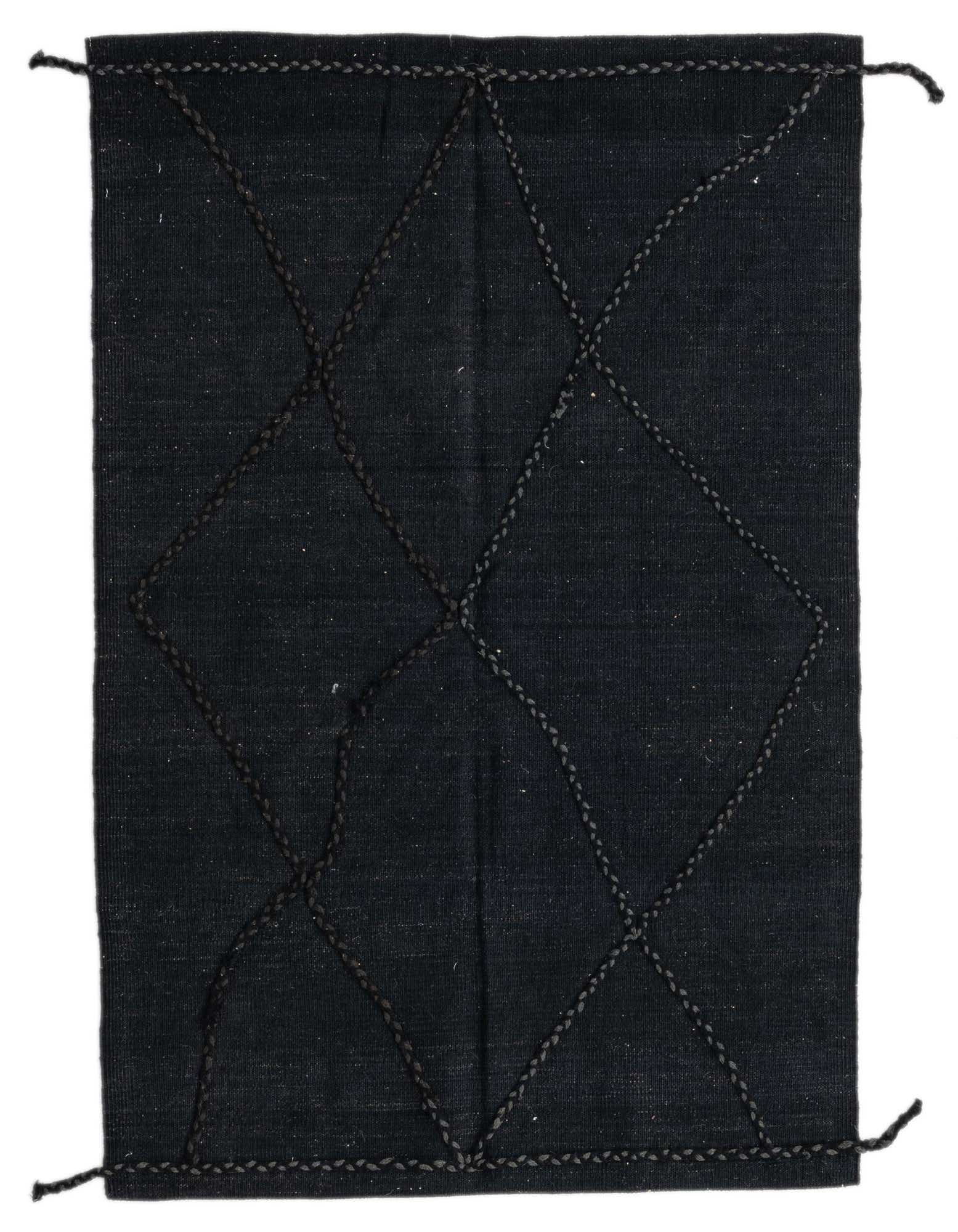 A 3x5 rectangular black wool shag rug with a tribal diamond pattern made from braided black yarn.