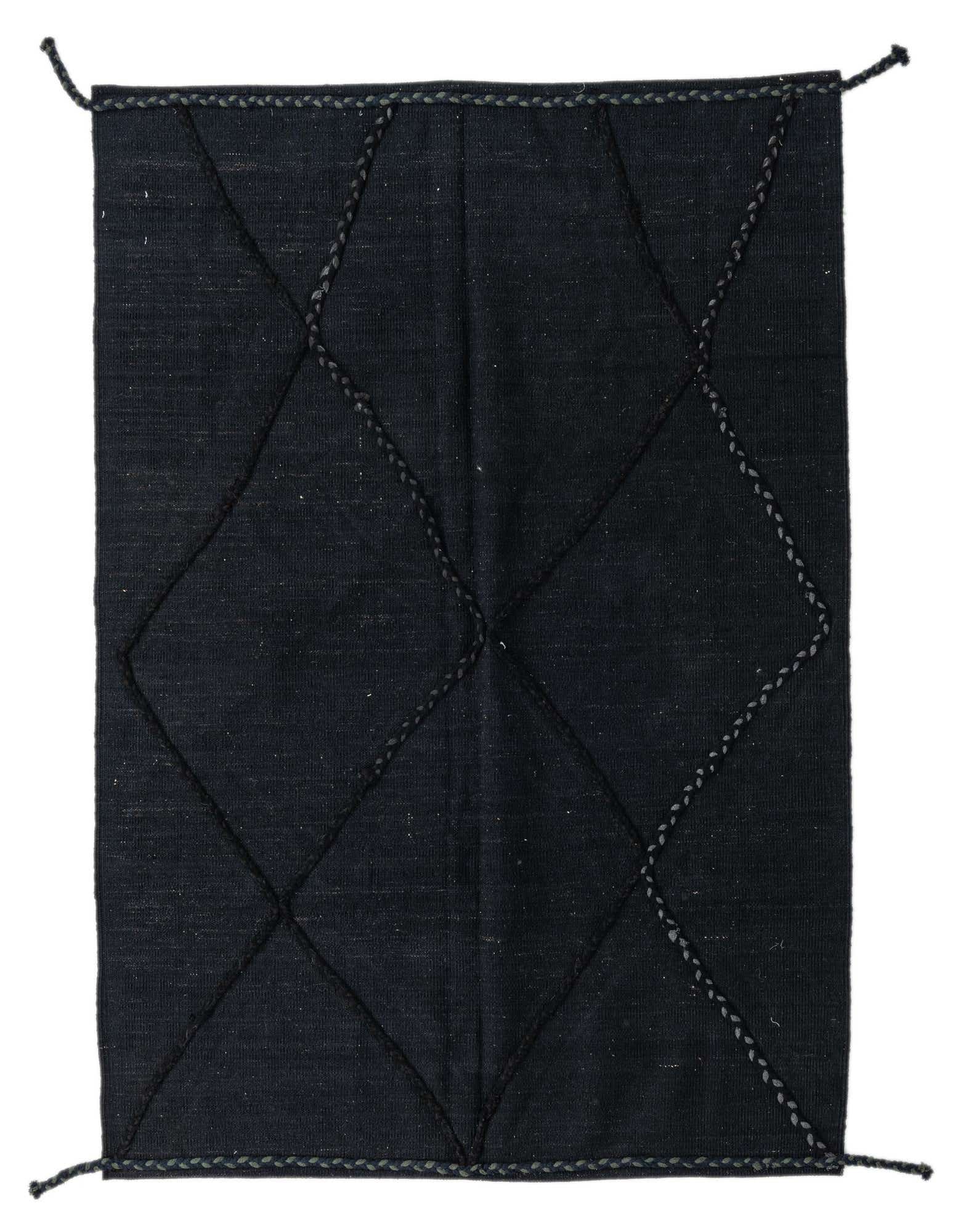 A 4x6 rectangular black shag rug with a modern tribal diamond pattern made from braided wool, suitable for a living room.