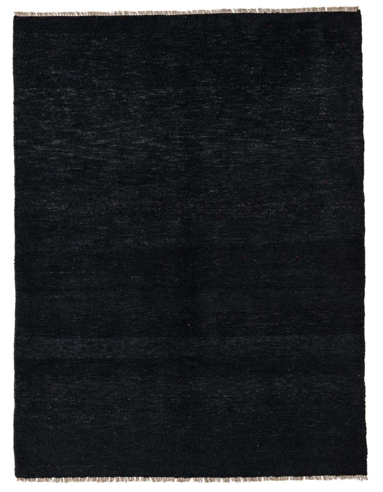A 5x8 rectangular black shag rug with subtle tribal patterns, suitable for a living room or bedroom.