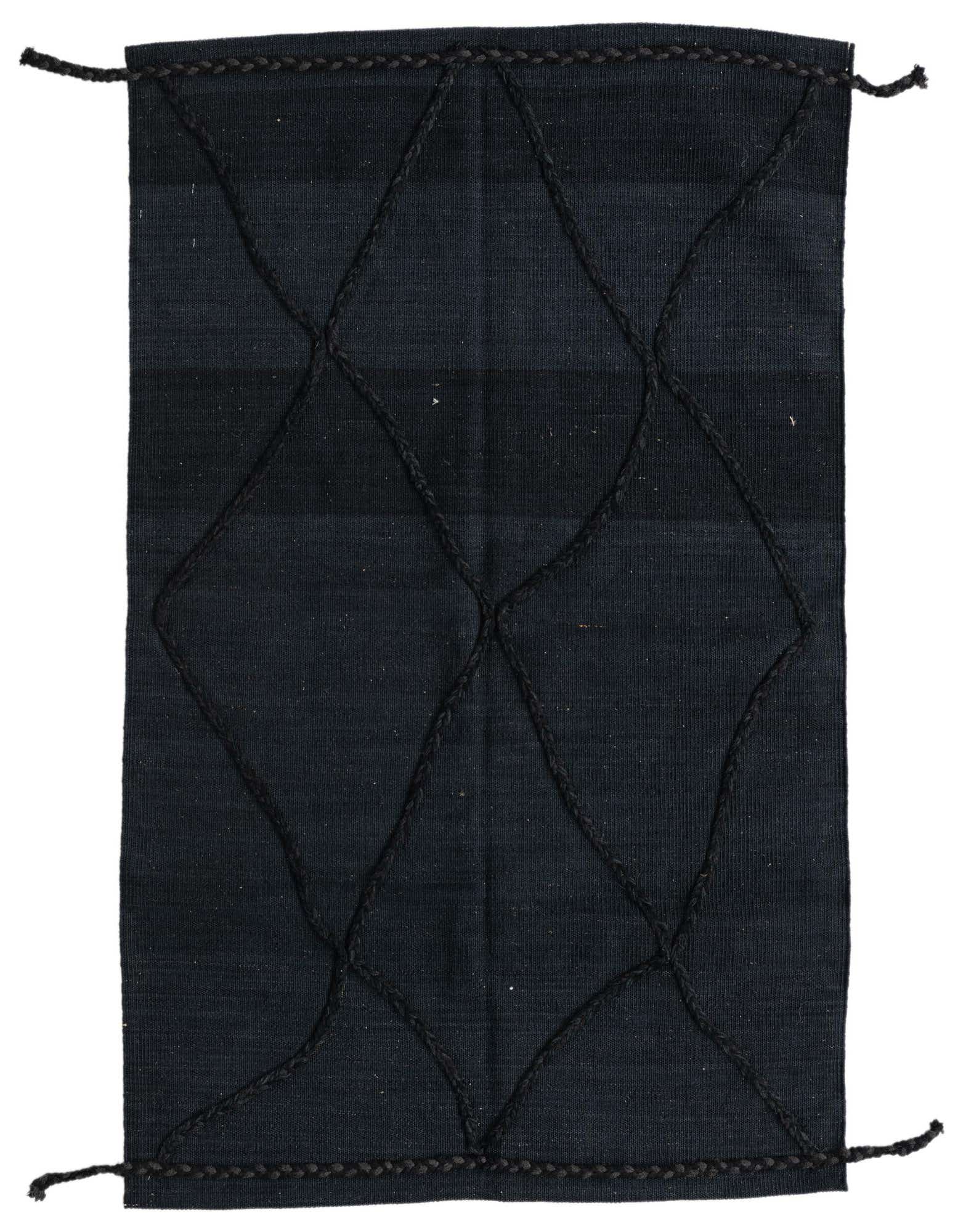 A 3x5 rectangular black wool shag rug with a braided diamond tribal pattern, handmade for indoor use.