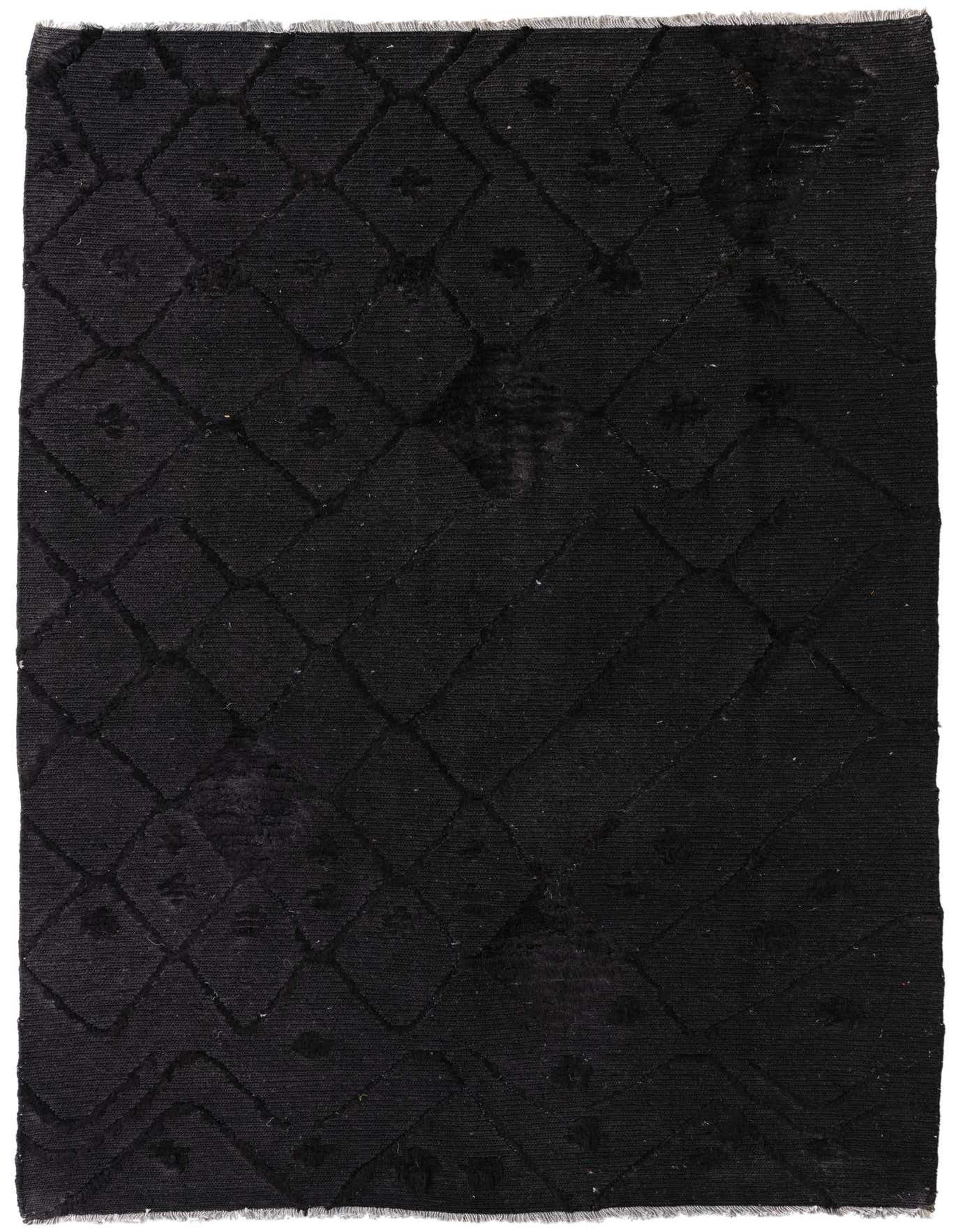 A 4x6 rectangular black shag rug with a subtle tribal diamond pattern, ideal for a modern living room.
