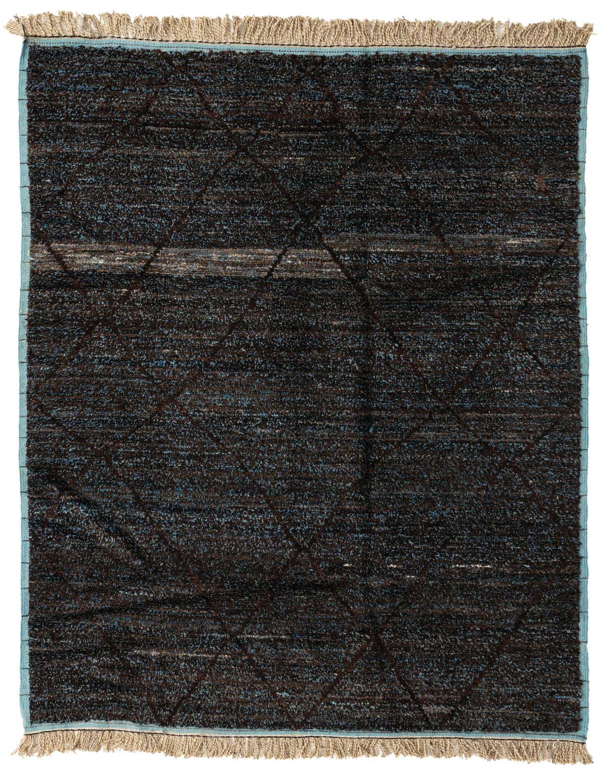 A 6x9 rectangular black shag rug with subtle blue and brown flecks, featuring a faint tribal geometric pattern and natural fringe.