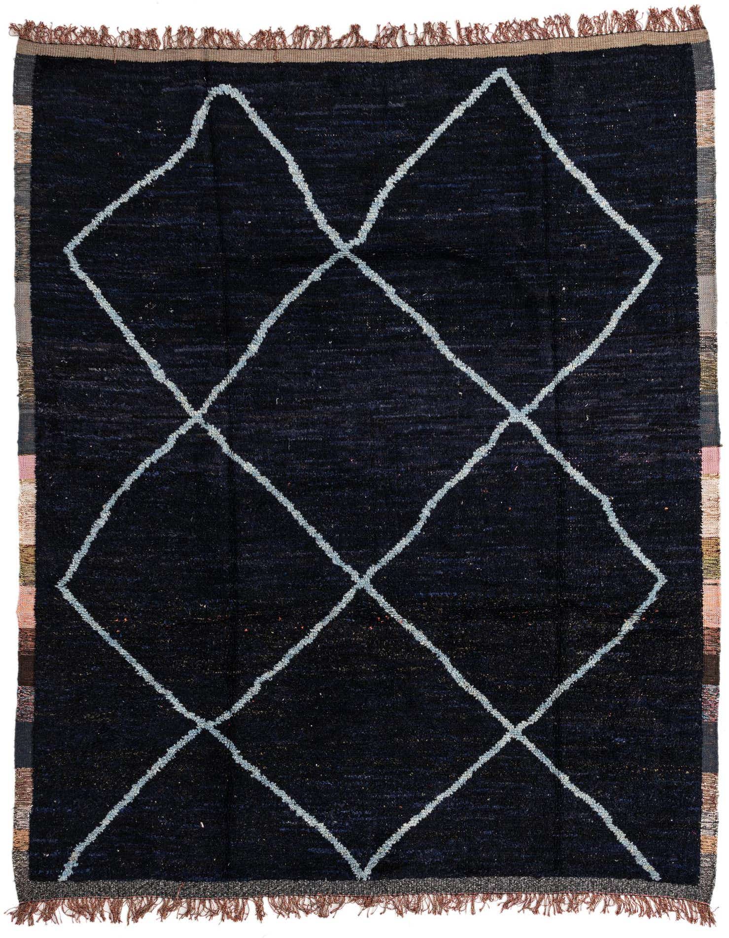 A rectangular 8x10 black shag rug with a white tribal diamond pattern and fringe, suitable for a living room.