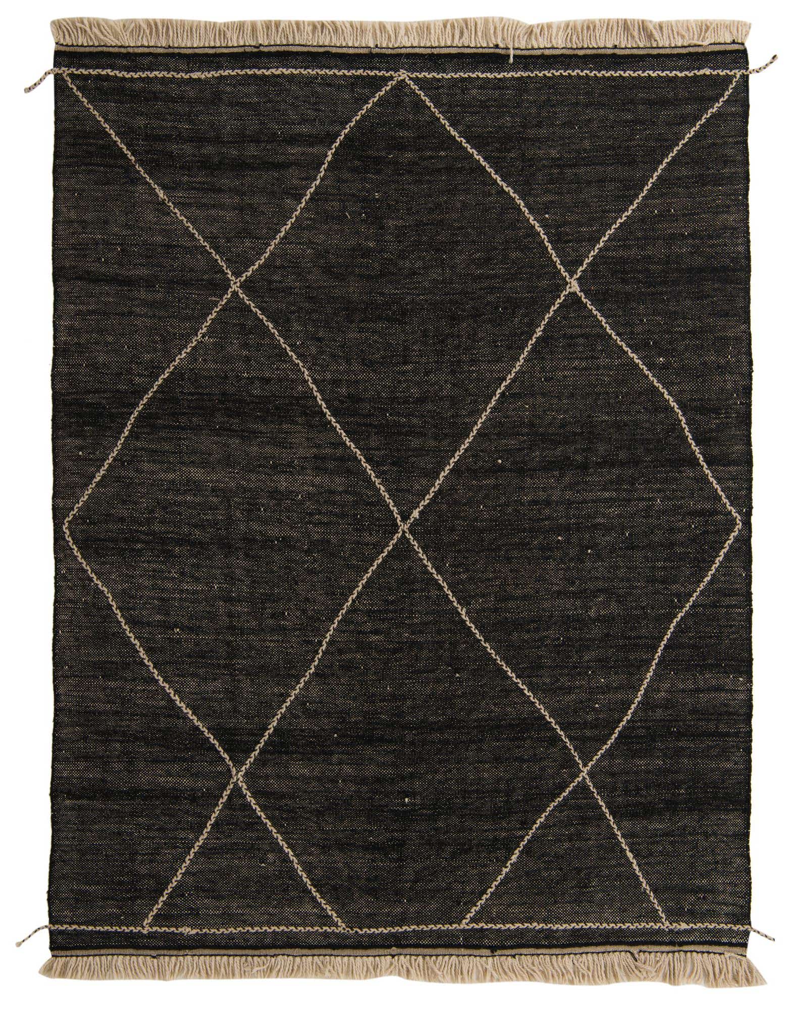 A rectangular 8x10 black wool shag rug with a cream tribal diamond pattern and fringed ends.
