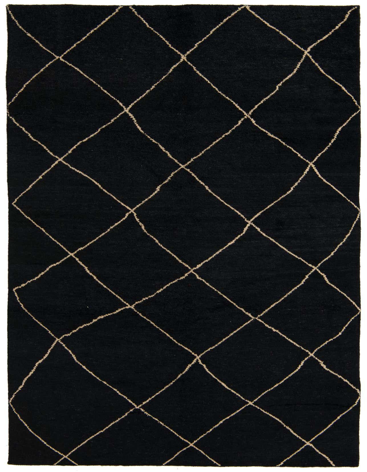 A 7x10 rectangular black shag rug with a cream tribal diamond pattern, ideal for a living room.
