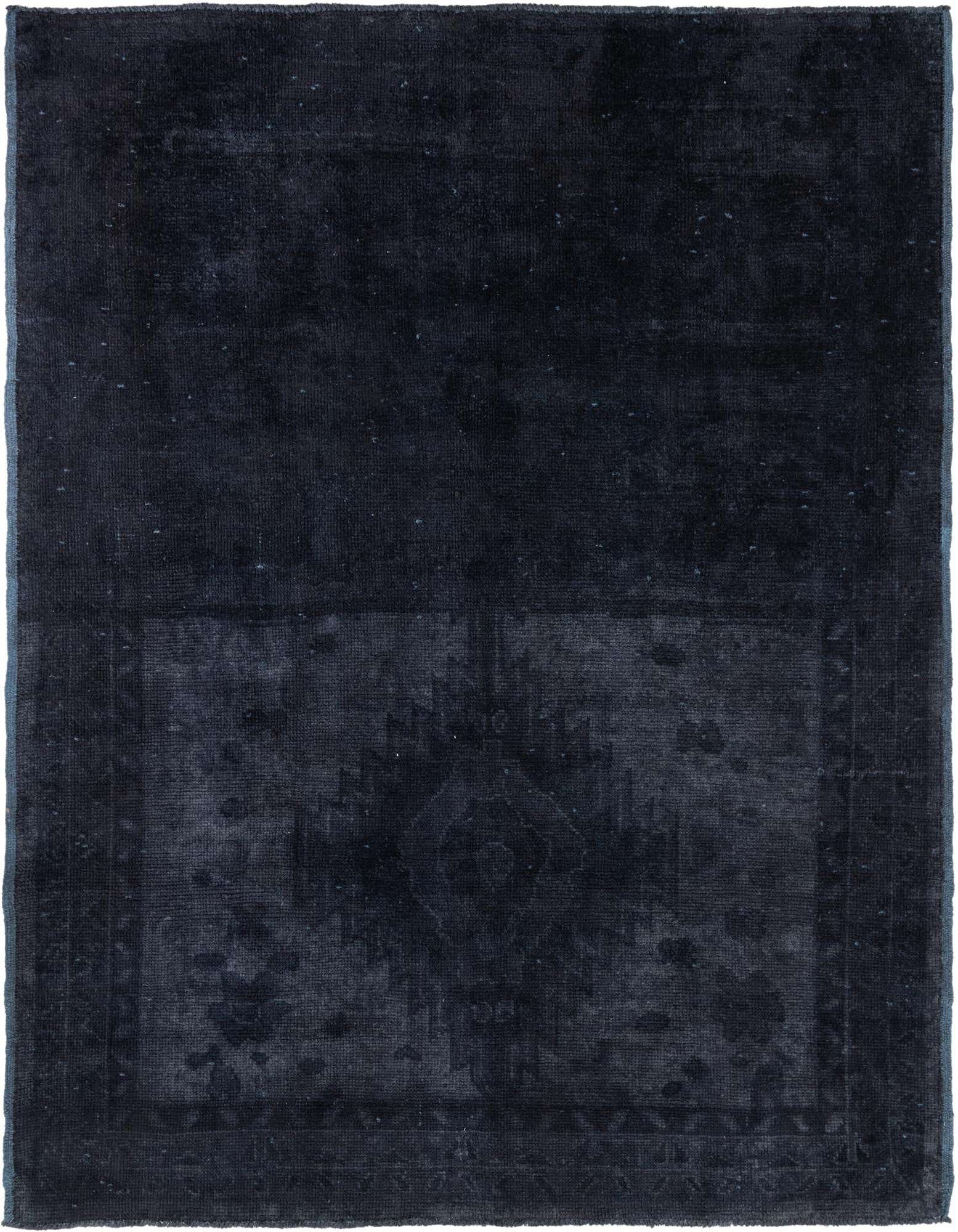 An 8x10 rectangular black shag rug with a subtle, faded tribal pattern, perfect for a modern living room.