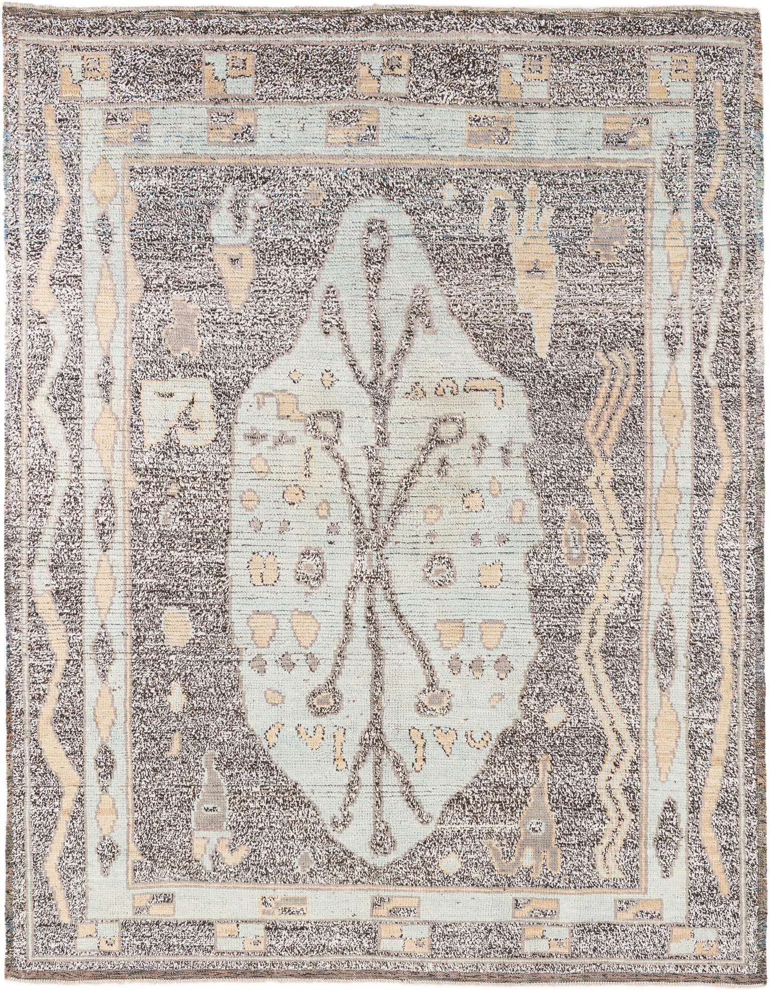 A rectangular 8x10 black and light blue wool shag rug with a central medallion and tribal patterns.