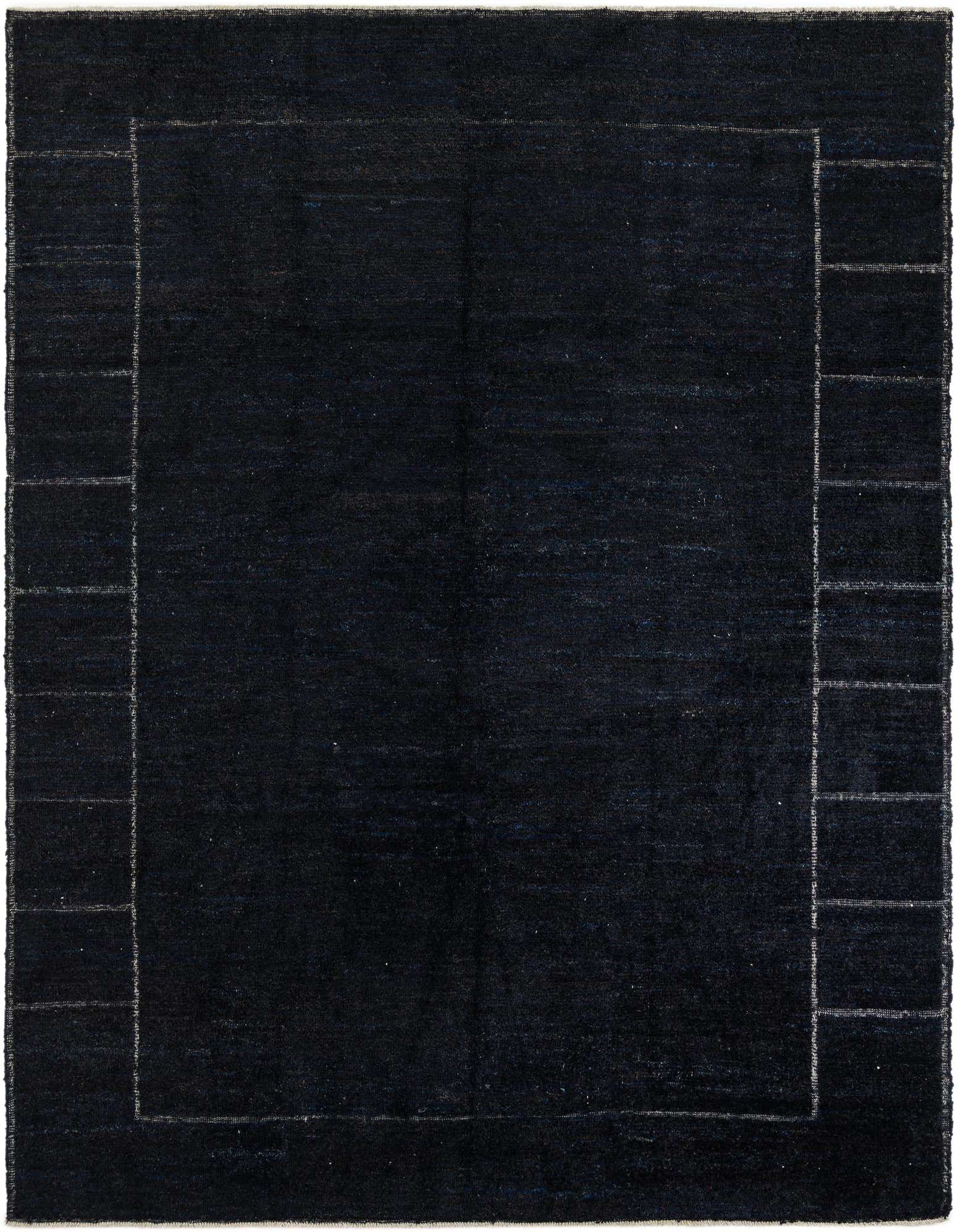 A 9x12 rectangular black shag rug with a subtle tribal border, perfect for a modern living room.