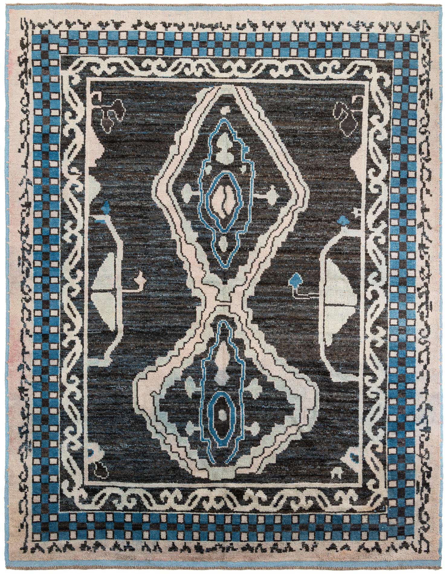 A 9x12 rectangular black wool shag rug with a large central medallion in light blue, white, and pink, surrounded by a tribal border.