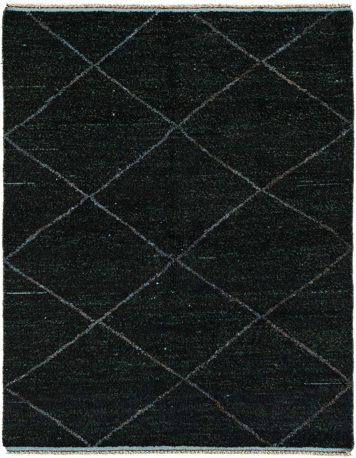 A rectangular 5x8 black shag wool rug with a subtle white diamond tribal pattern, perfect for a living room.