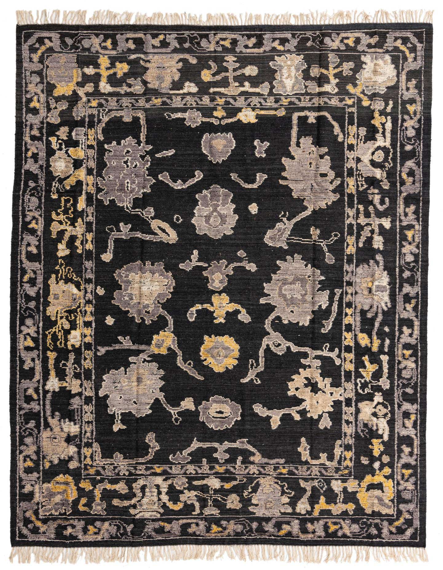 A 9x12 rectangular black wool area rug with a modern abstract pattern in gray, beige, and yellow tones, featuring a decorative border and fringe.