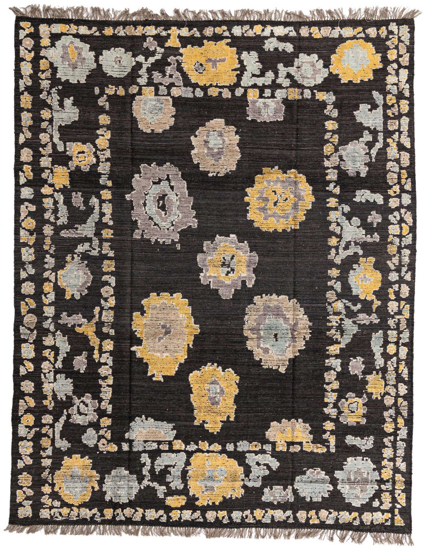 A 9x12 rectangular black wool rug with a modern abstract pattern of yellow, grey, and light blue floral-like motifs.