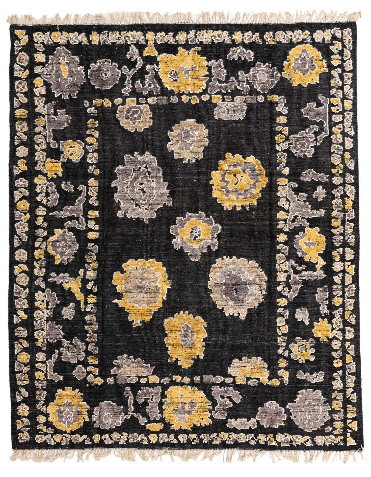 A rectangular 8x10 black wool rug with a modern floral pattern in yellow and gray, featuring fringed edges.