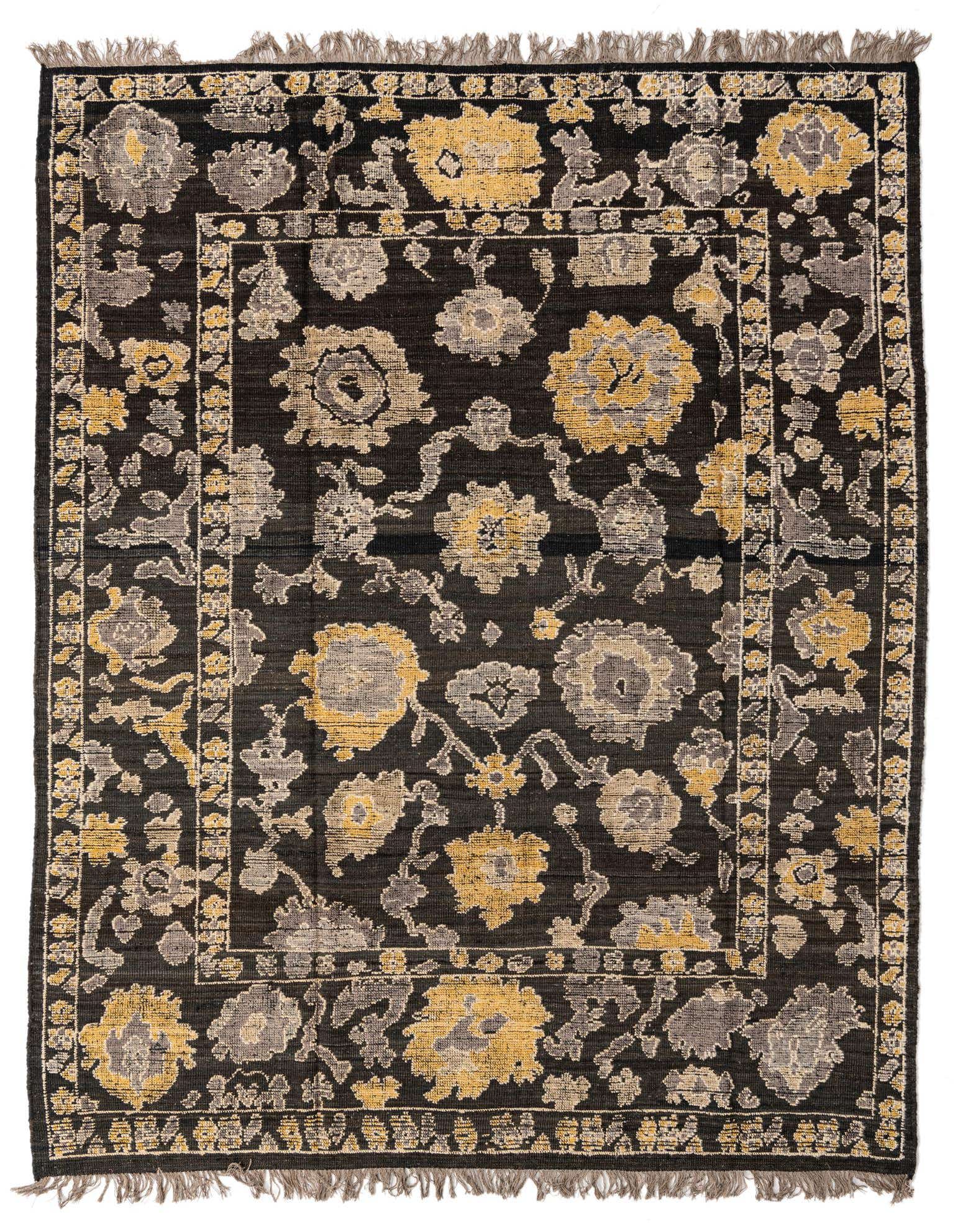 A rectangular 8x10 black wool rug with a modern floral pattern in yellow and gray, featuring a textured pile and fringe.