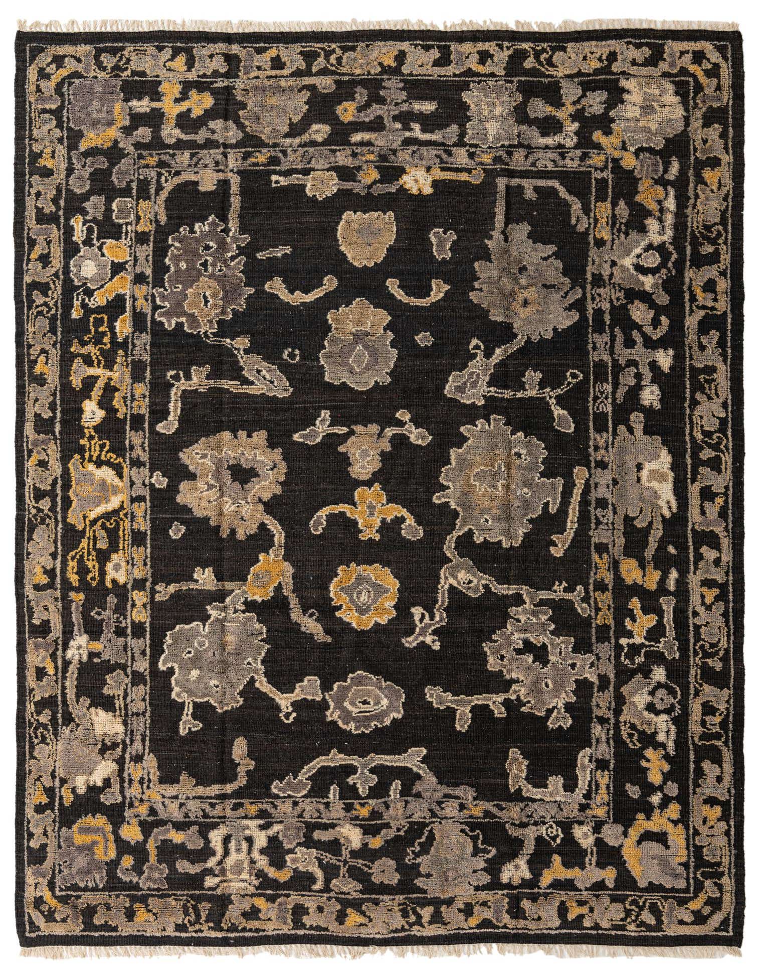 A 9x12 rectangular black wool rug with a modern Oushak pattern in grey and gold tones, featuring a decorative border and fringe.