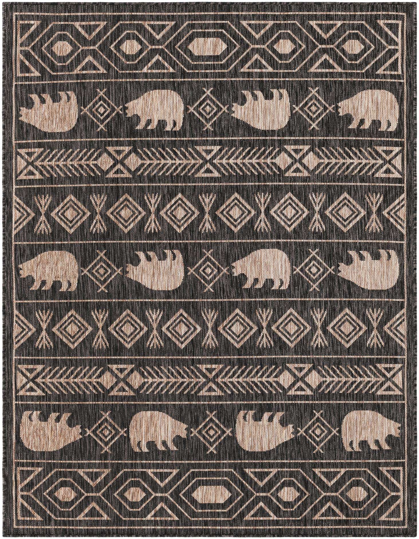 A 5x7 rectangular black and beige flatweave rug with a Southwestern tribal pattern featuring bear silhouettes and geometric shapes.