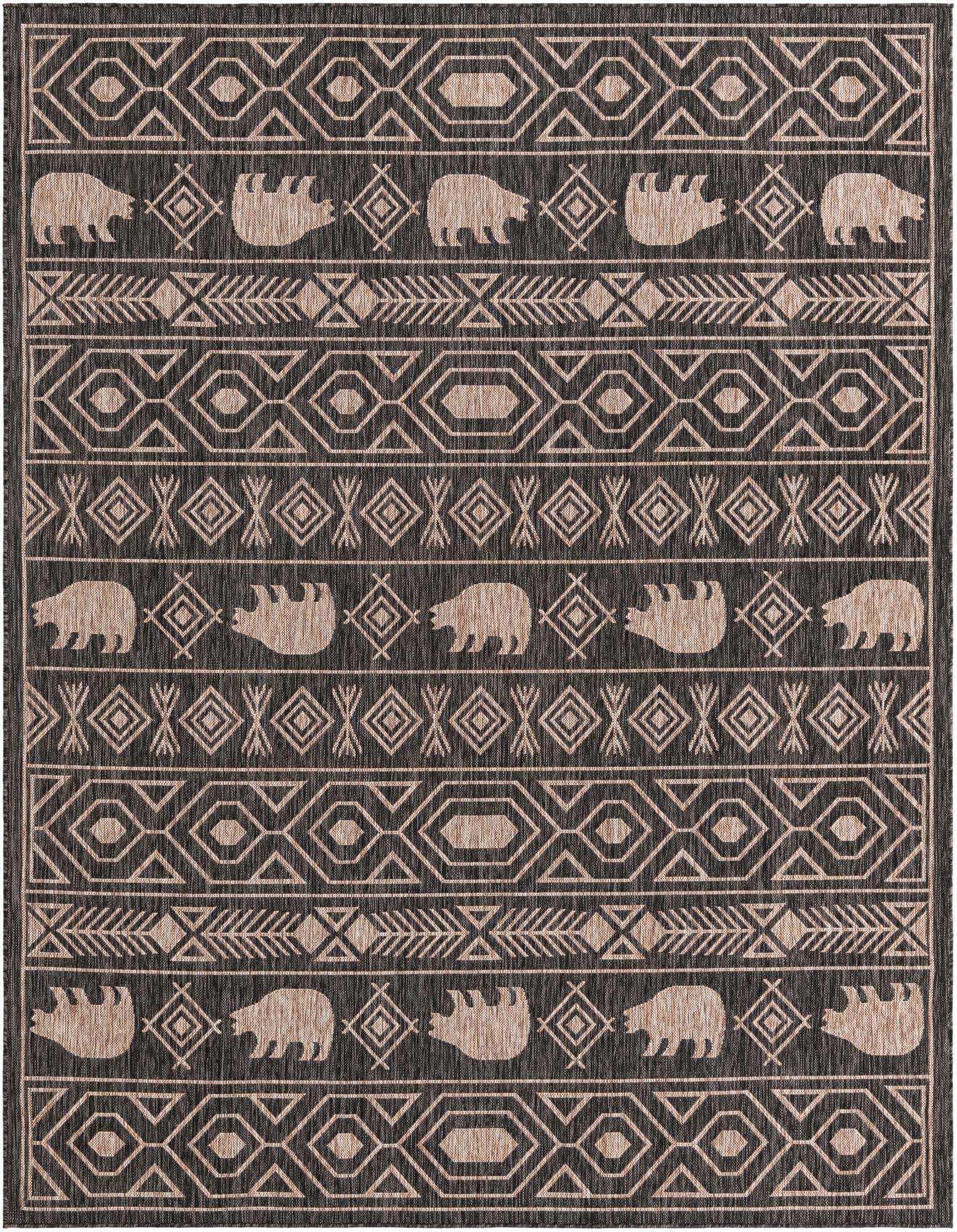An 8x10 rectangular black and beige tribal rug with bear, arrow, and geometric patterns, suitable for indoor or outdoor use.