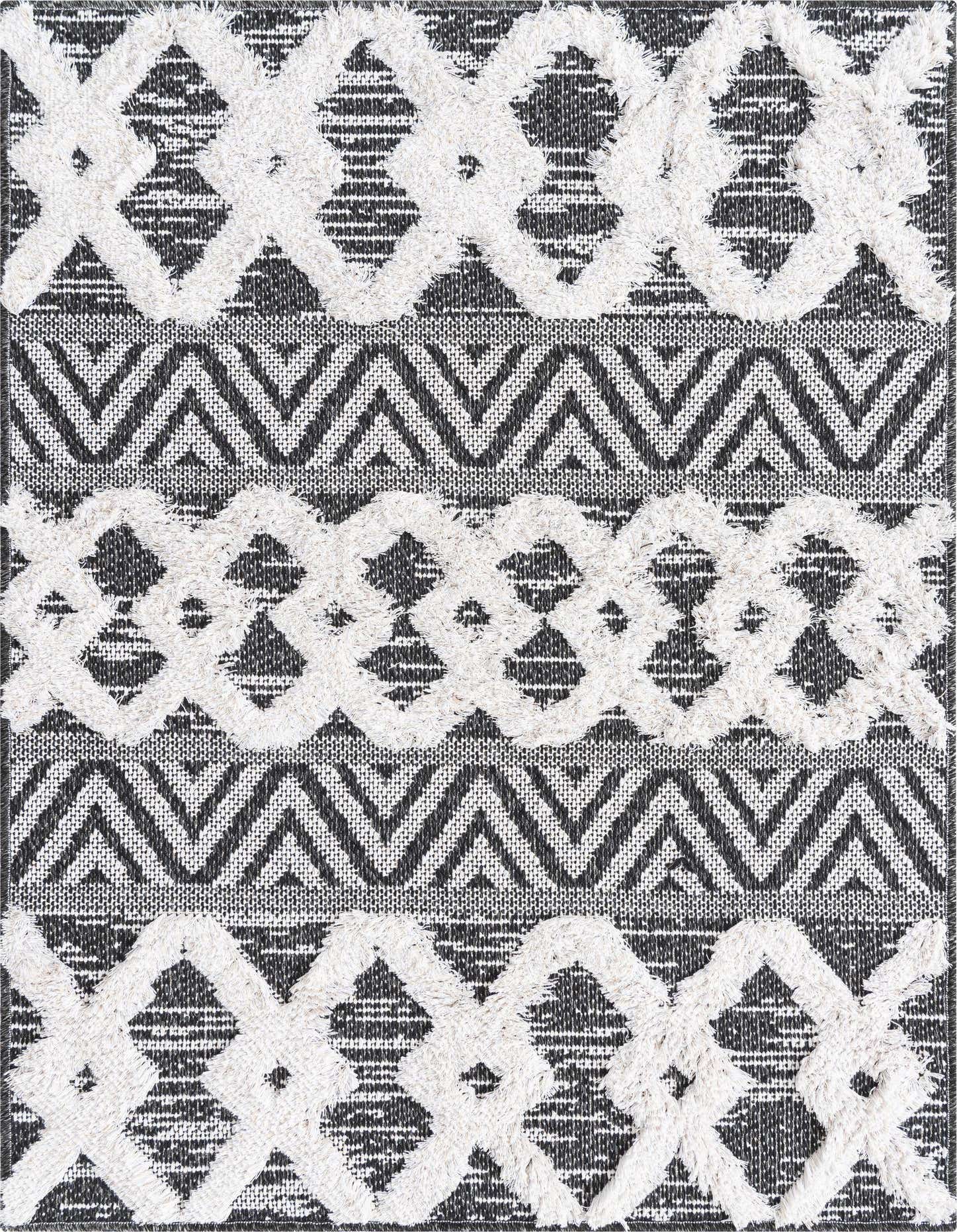 A 2x3 rectangular black and white tribal rug with a textured, high-low pile, featuring abstract geometric patterns.