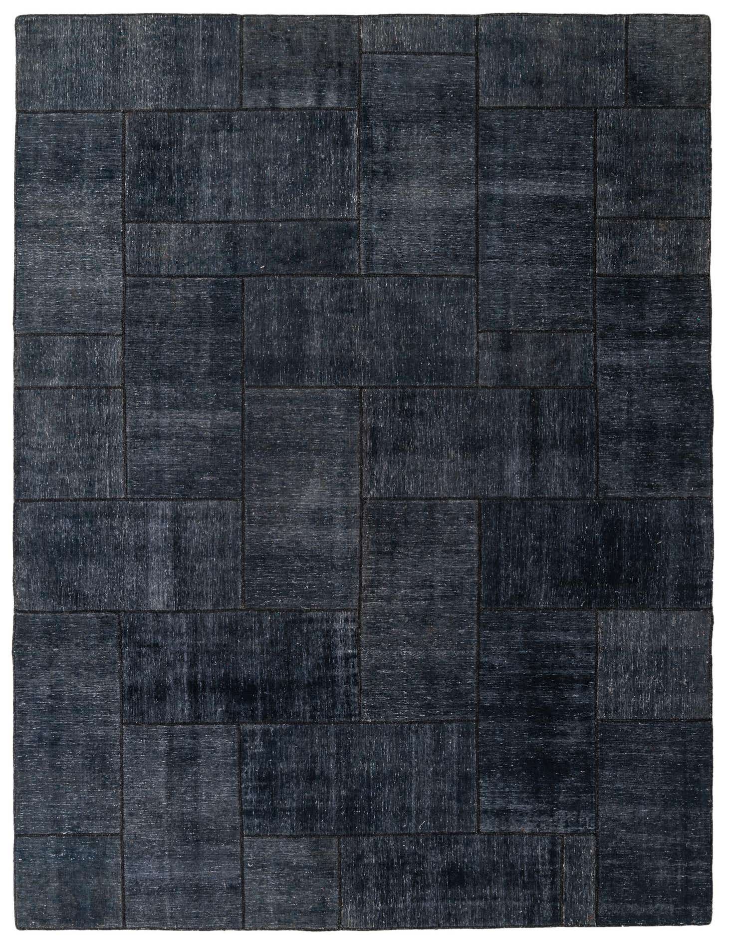 An 8x12 rectangular black wool area rug featuring a modern patchwork design with varying shades and textures.