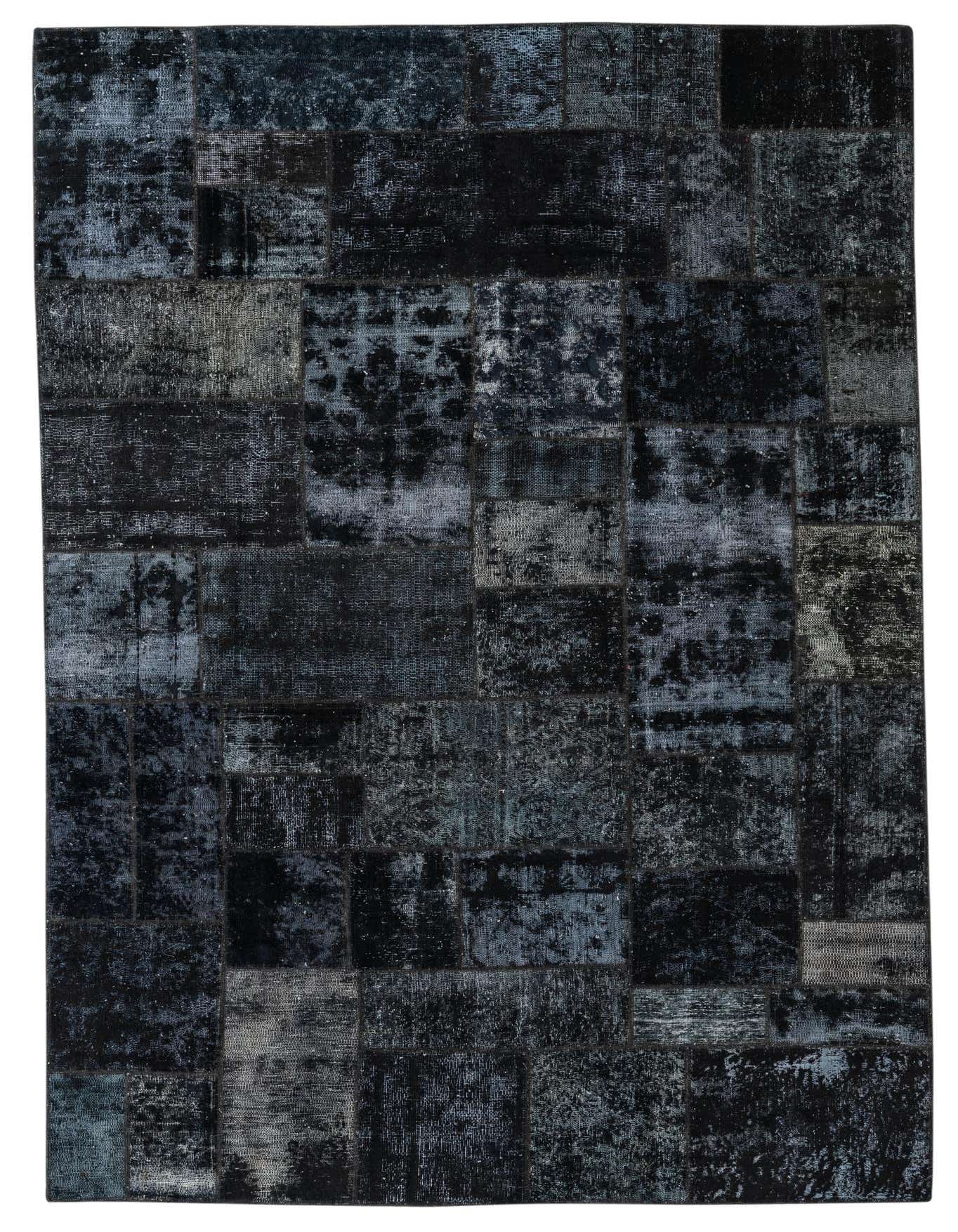 A 6x9 rectangular Ultra Vintage wool rug featuring a distressed black and dark gray patchwork design.
