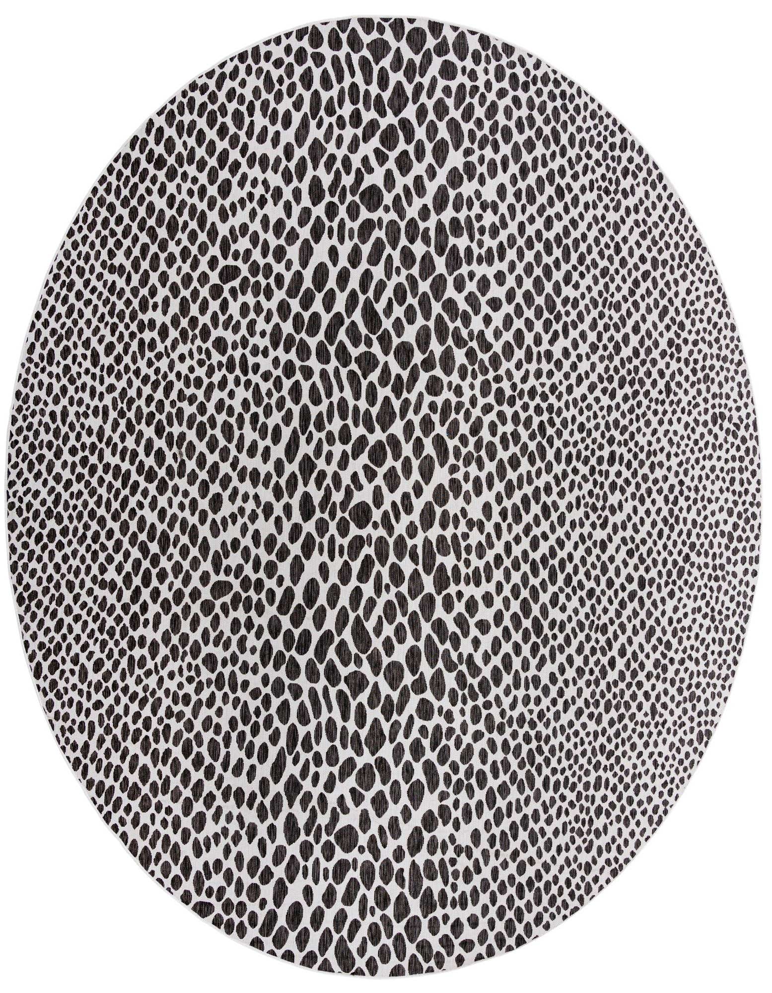 A large round black and white abstract patterned rug, suitable for indoor or outdoor spaces like a patio.