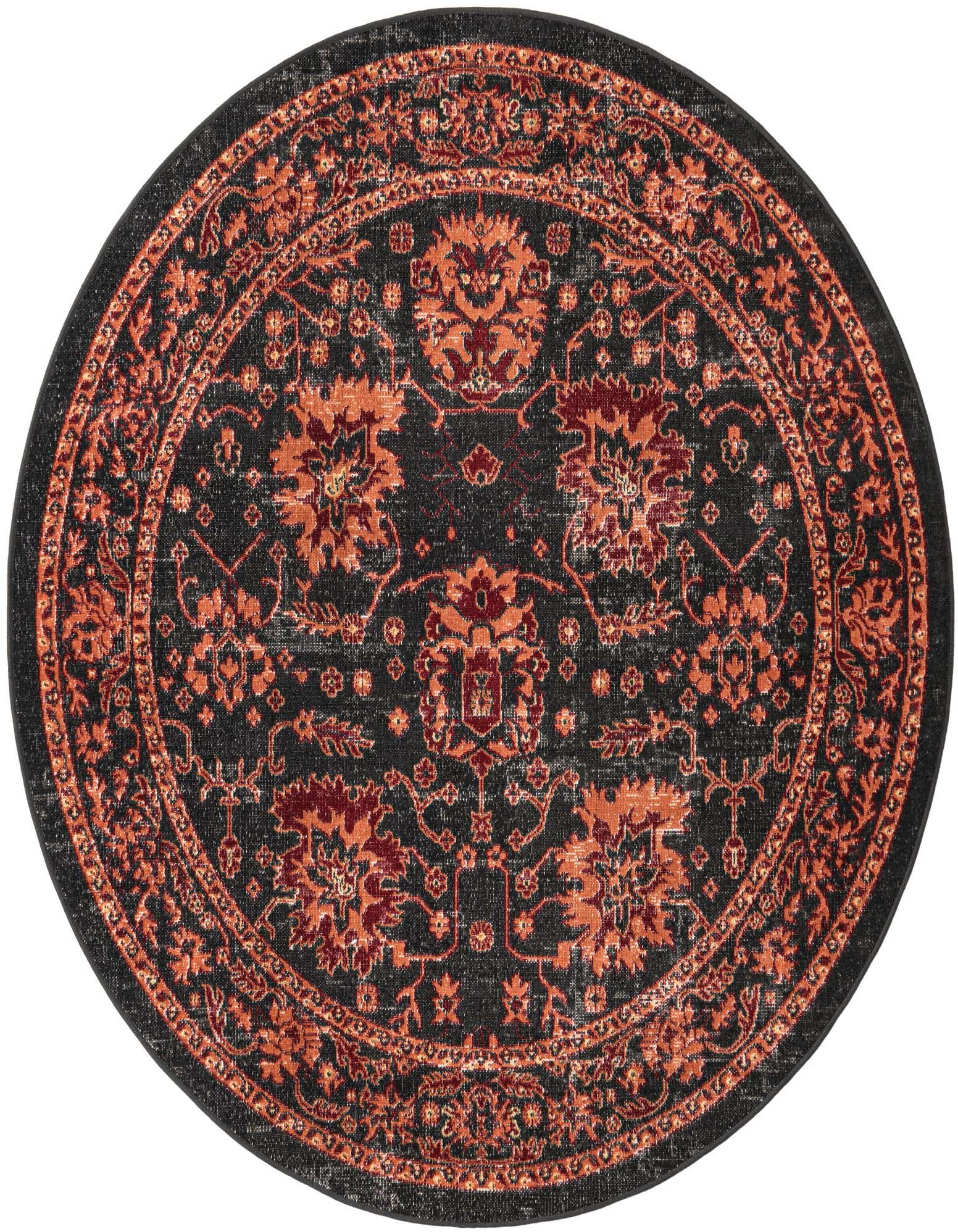 A round black rug with a distressed traditional pattern in shades of orange and red, suitable for a patio.