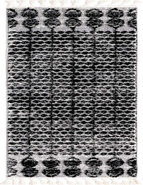 A black and white tribal runner rug with a textured, high pile and decorative tassels, ideal for a hallway.