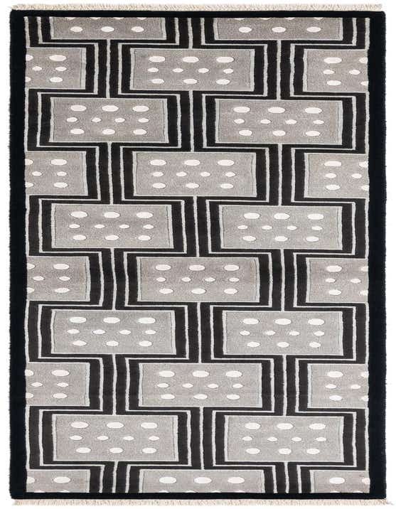 A 10 ft runner rug with a modern Persian pattern in black, gray, and white, featuring geometric squares with polka dots.