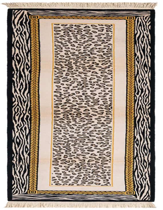 A long runner rug with a central leopard print panel, bordered by gold braided patterns and outer black and white zebra stripes, with fringed ends.