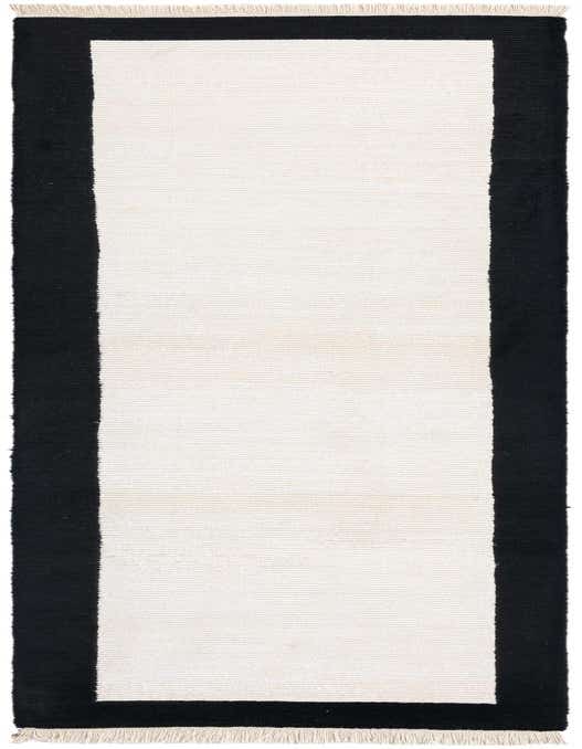 A 10 ft runner rug from the Darya collection, featuring a cream center with a bold black border and fringe.